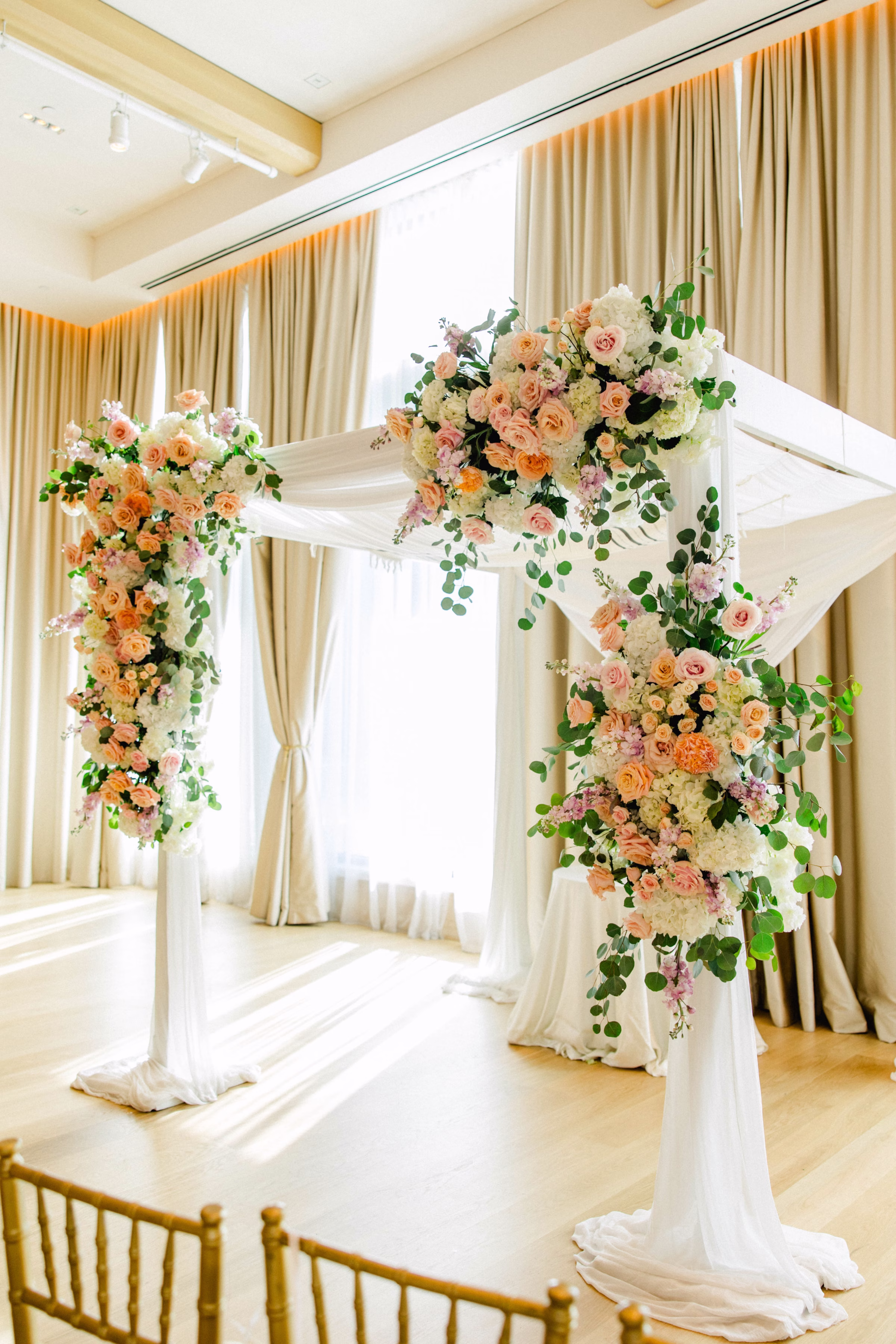 Spring Pastel Roses, Hydrangeas Blush, Peach, Cream, White Wedding Ceremony Altar Floral Arrangement Decor Inspiration | White Draping Ceremony Decor Ideas | Downtown Event Venue The Edition Hotel Tampa