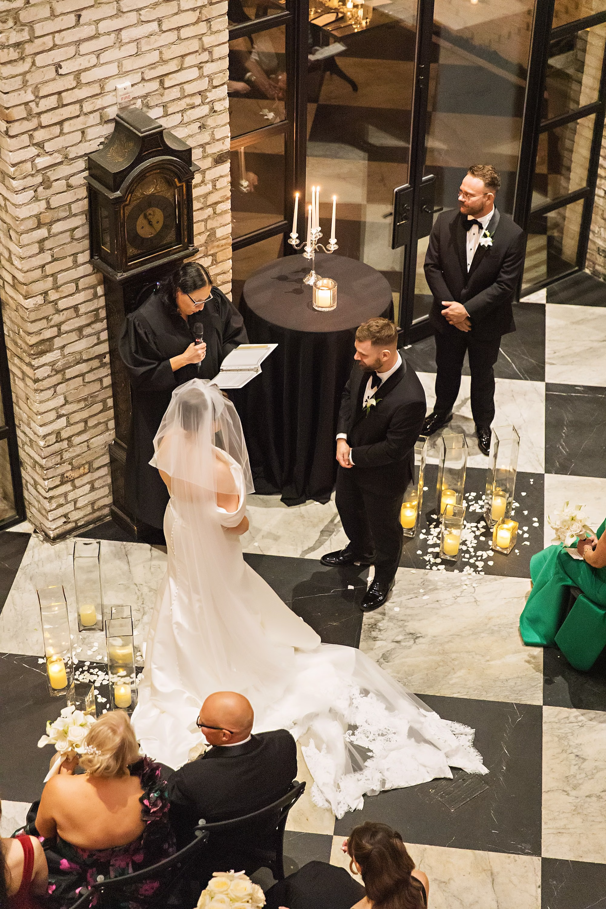 Bride and Groom Wedding Ceremony Vow Exchange Wedding Portrait | Modern Timeless Indoor Wedding Ceremony on Checkered Floor with Minimalistic Design Details | Intimate Timeless Black and White Wedding Ceremony Inspiration | South Tampa Venue Oxford Exchange | Tampa Bay Photographer Limelight Photography