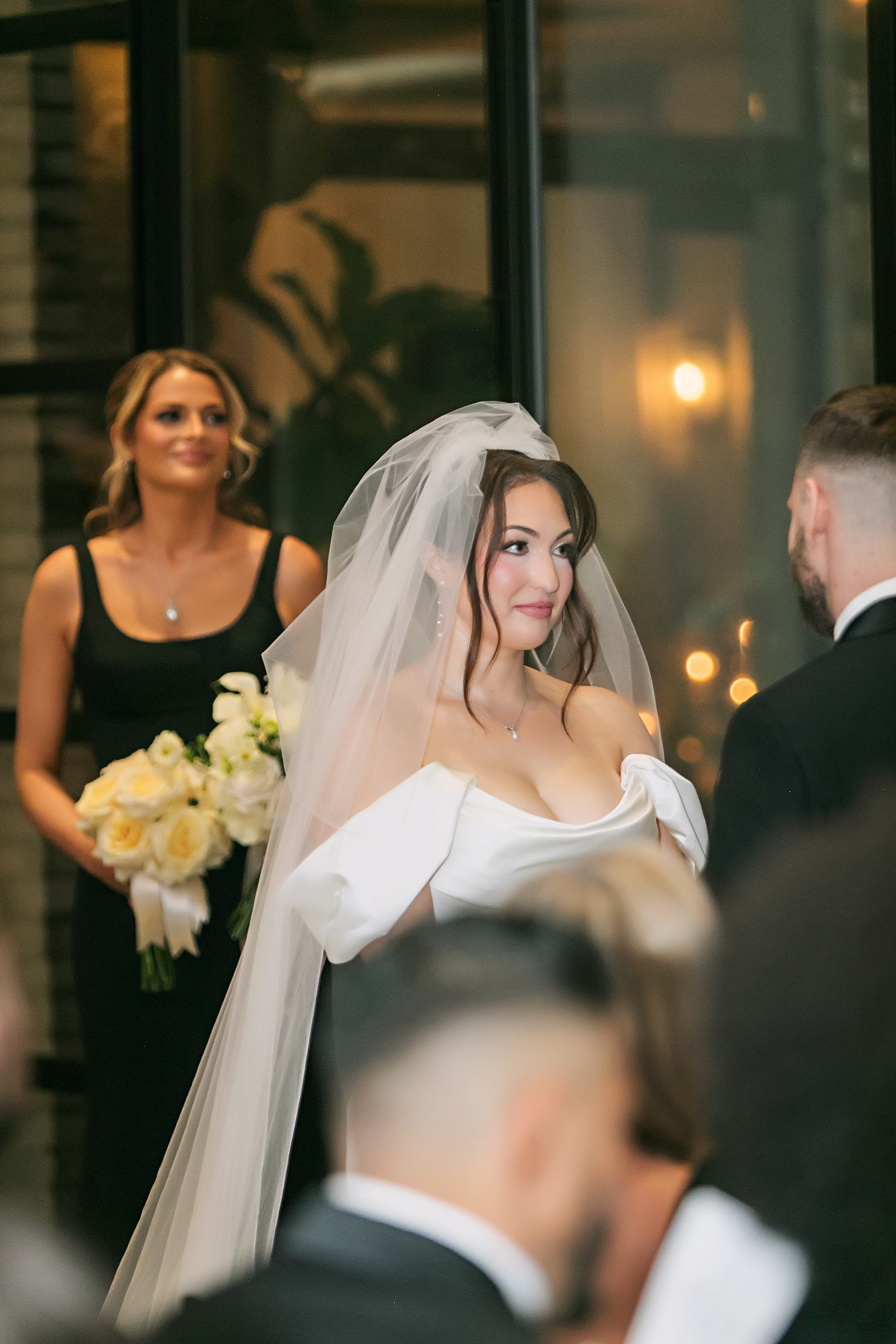 Bride and Groom Wedding Ceremony Vow Exchange Wedding Portrait | Classic White Rose Bridal Bouquet Ideas | Off the Shoulder White Wedding Gown with Traditional Tulle Veil Inspiration