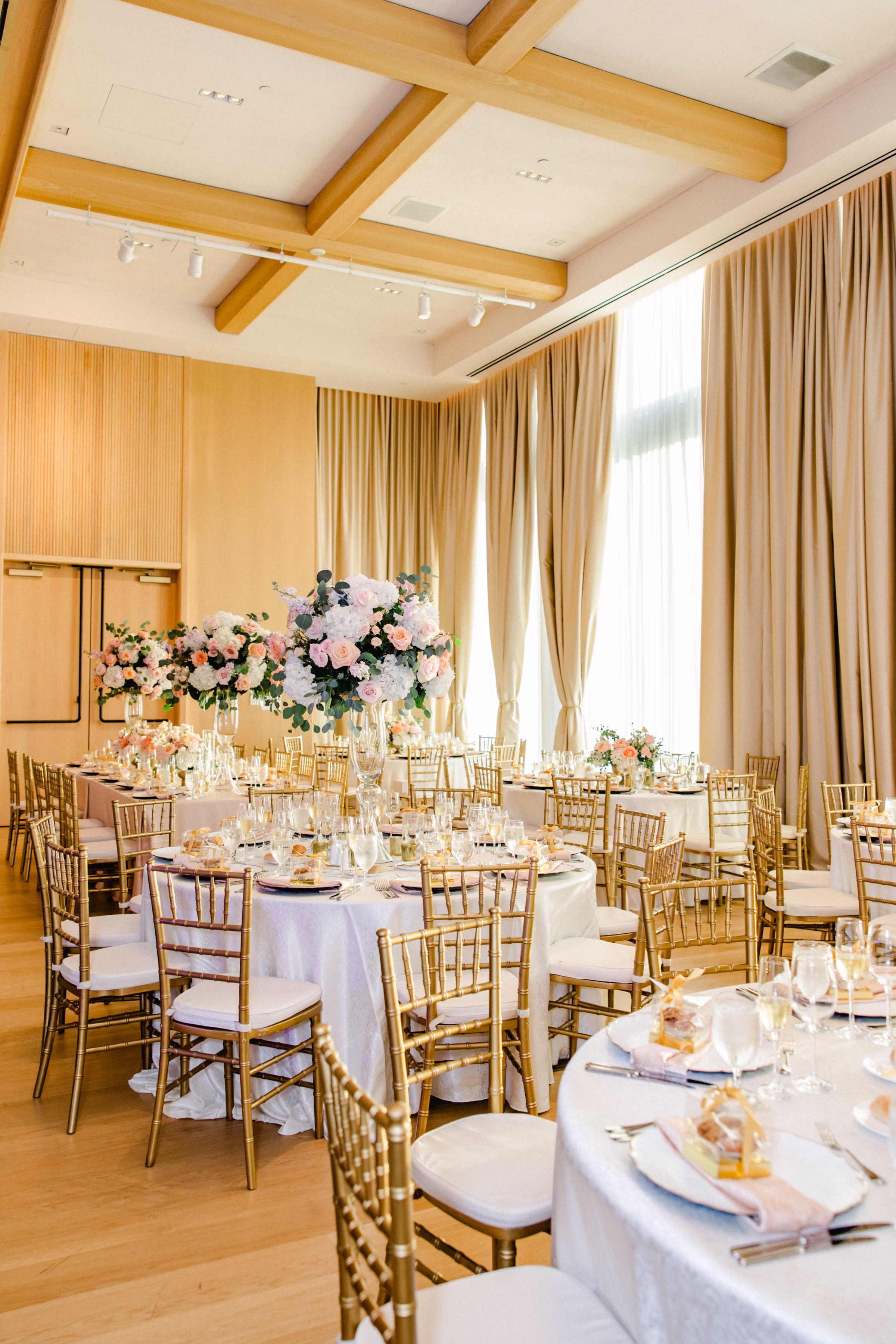 Luxurious Ballroom Wedding Reception | Modern Gold Chiavari Chairs | Tall Glass Centerpieces with Pastel Pink, White Hydrangeas and Roses Flower Arrangement Centerpiece Ideas | Downtown Event Venue The Edition Hotel Tampa