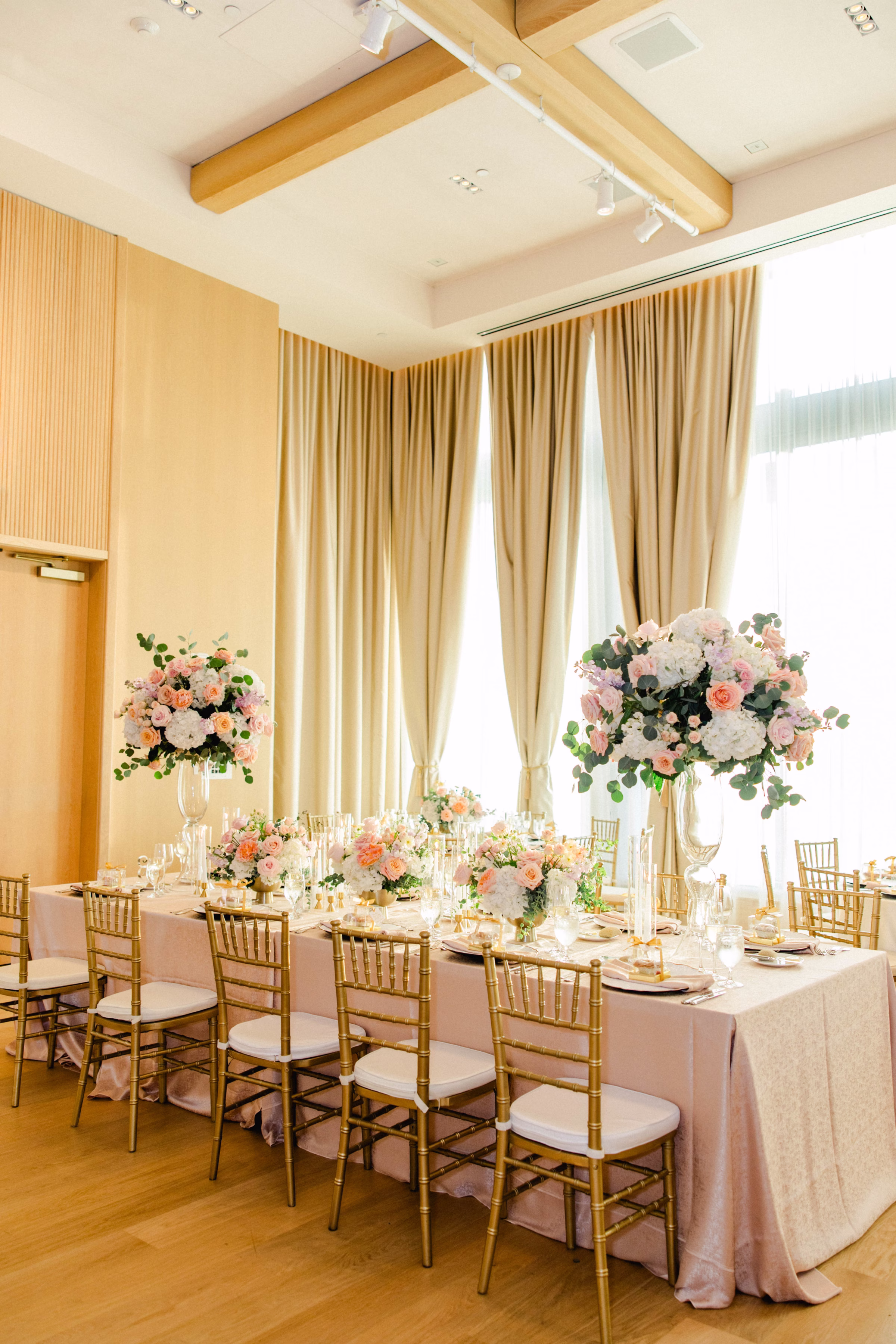 Luxurious Ballroom Wedding Reception | Modern Gold Chiavari Chairs | Tall Glass Centerpieces with Pastel Pink, White Hydrangeas and Roses Flower Arrangement Centerpiece Ideas | Downtown Event Venue The Edition Hotel Tampa