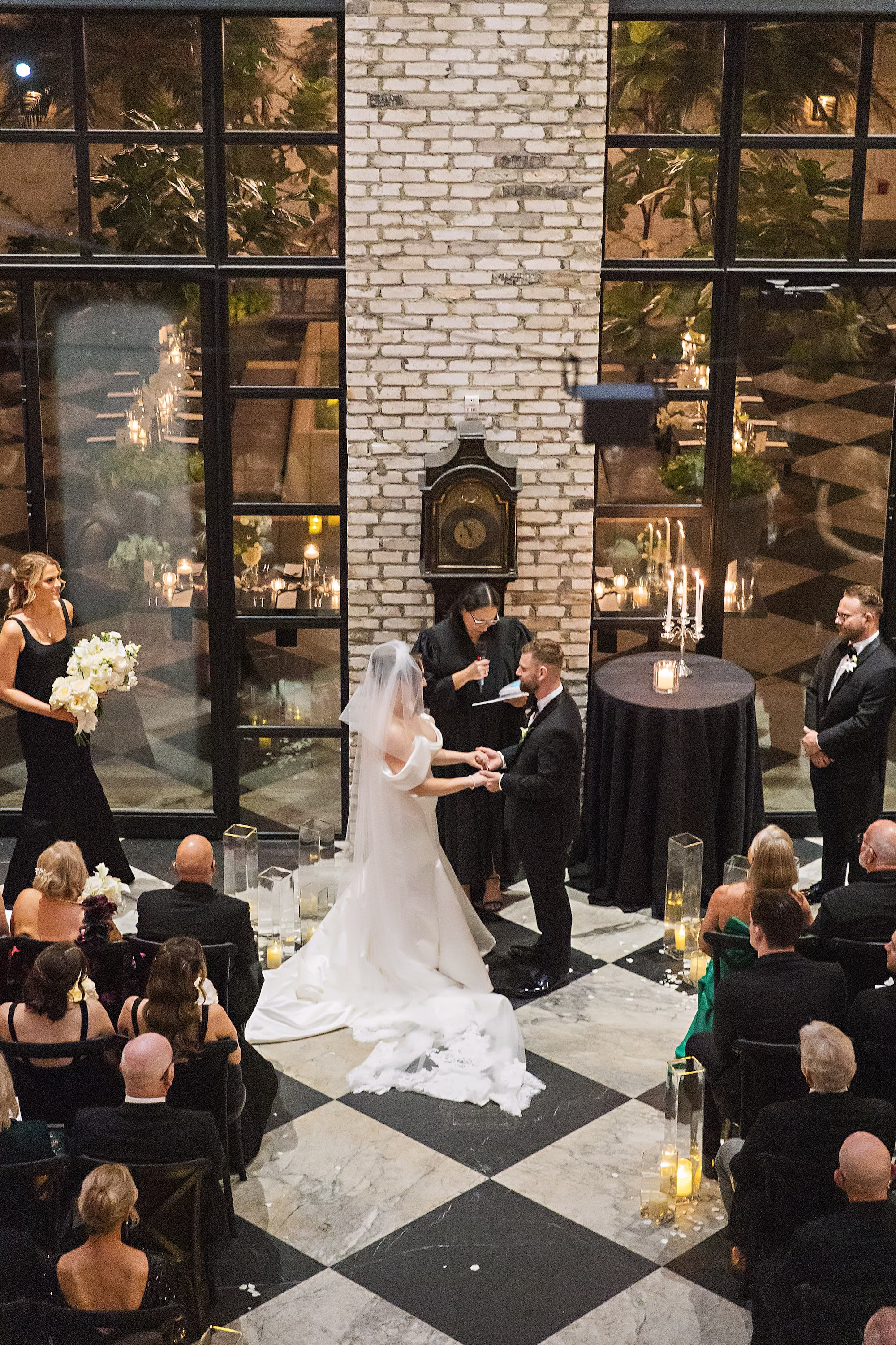 Bride and Groom Wedding Ceremony Vow Exchange Wedding Portrait | Modern Timeless Indoor Wedding Ceremony on Checkered Floor with Minimalistic Design Details | Intimate Timeless Black and White Wedding Ceremony Inspiration | South Tampa Venue Oxford Exchange | Tampa Bay Photographer Limelight Photography