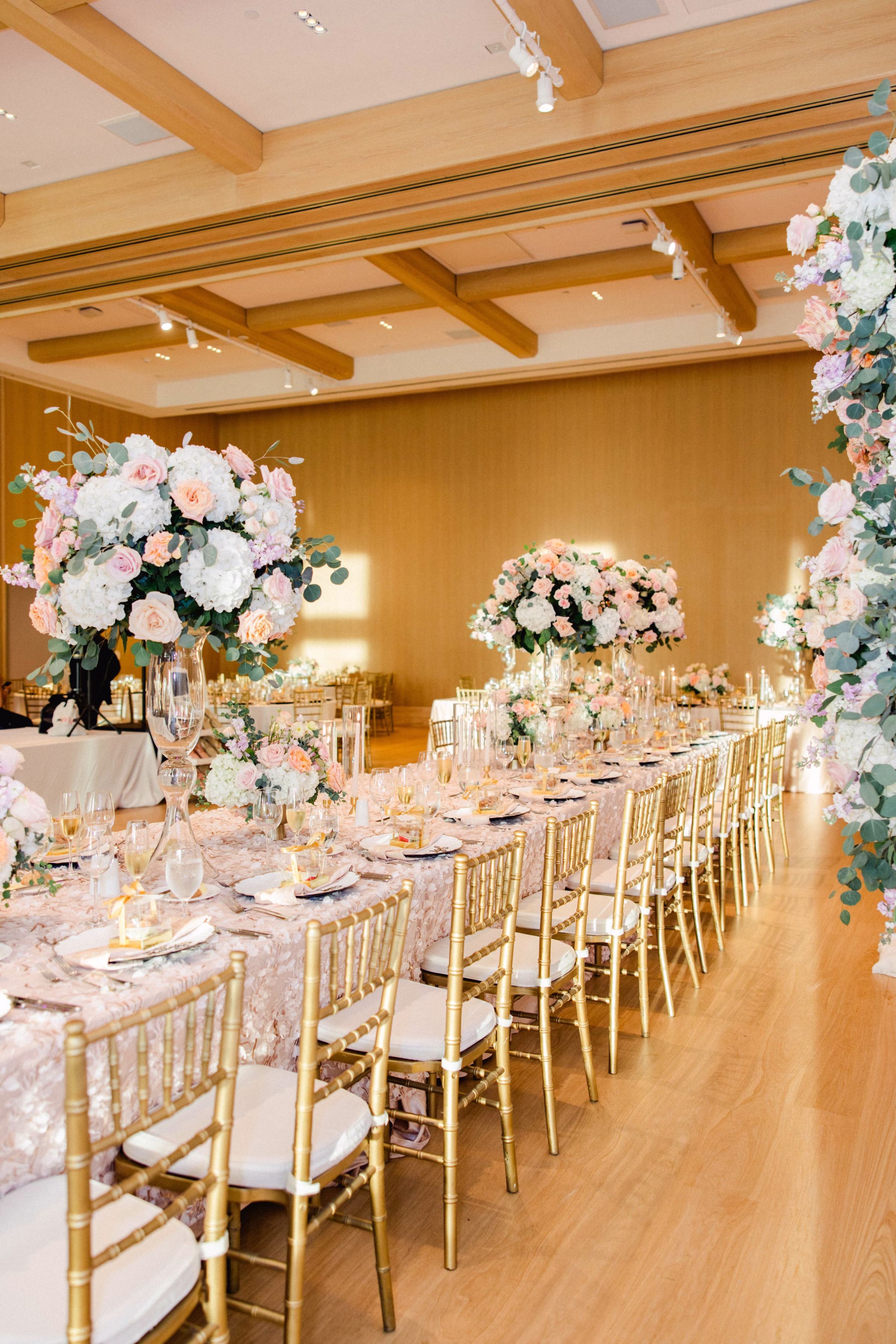 Luxurious Ballroom Wedding Reception | Modern Gold Chiavari Chairs | Tall Glass Centerpieces with Pastel Pink, White Hydrangeas and Roses Flower Arrangement Centerpiece Ideas | Downtown Event Venue The Edition Hotel Tampa