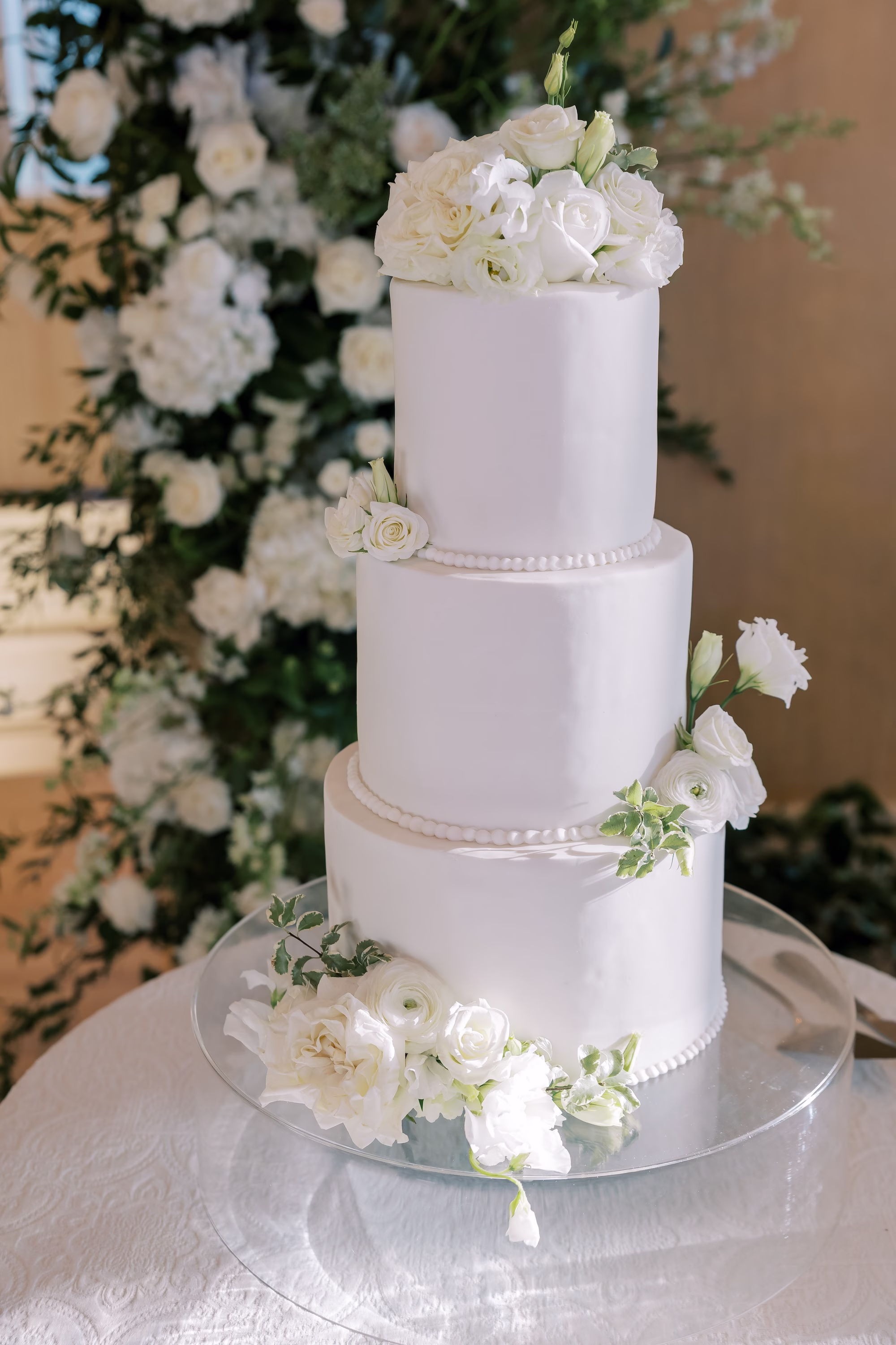 White Three-Tiered Round Wedding Cake with White Flowers Ideas | Tampa Bay Florist Bruce Wayne Florals