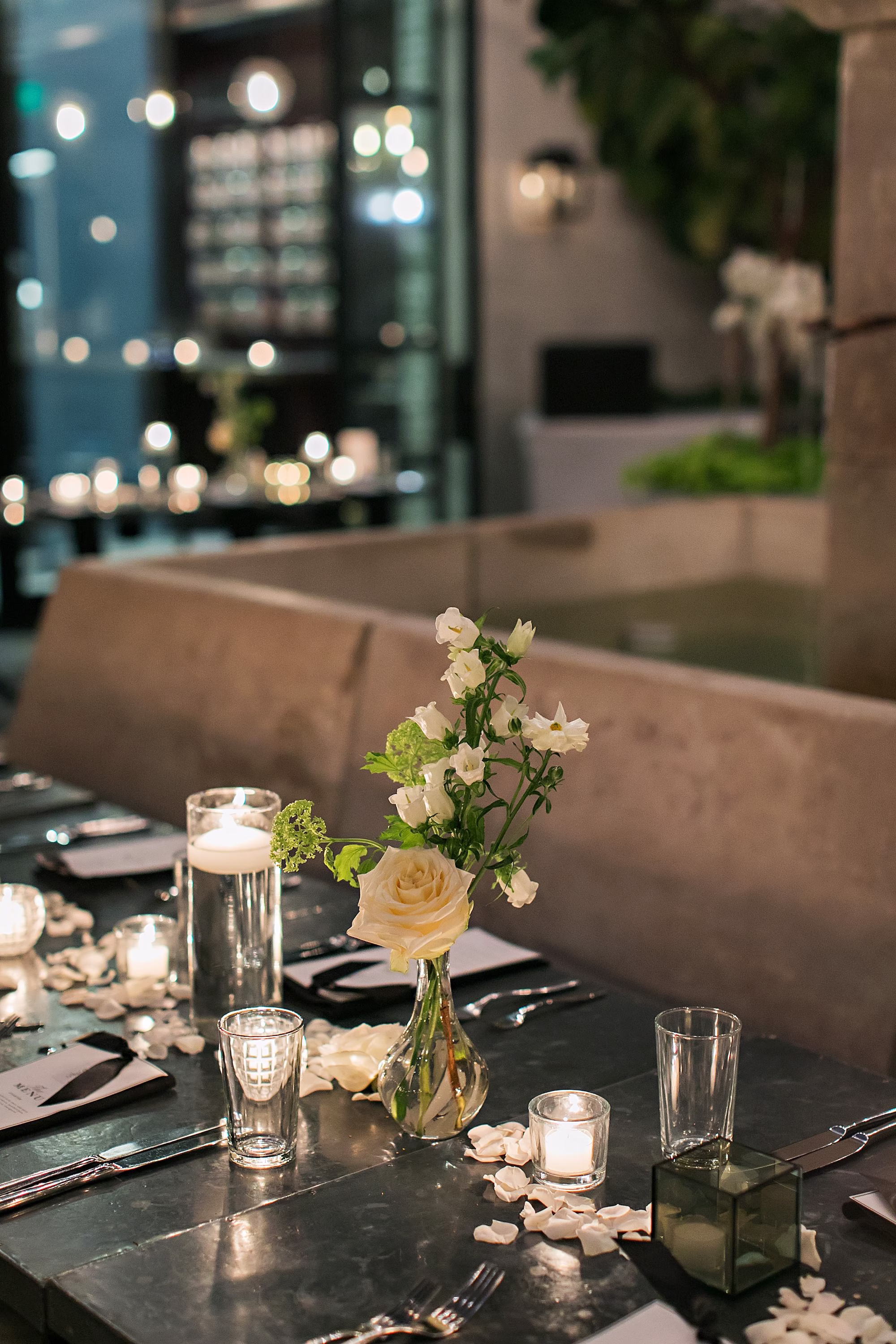 Simple Timeless Single White Rose with White Florals in Bud Vase Wedding Reception Centerpiece Inspiration | Romantic Floating Tea Candles Tablescape Decor Ideas