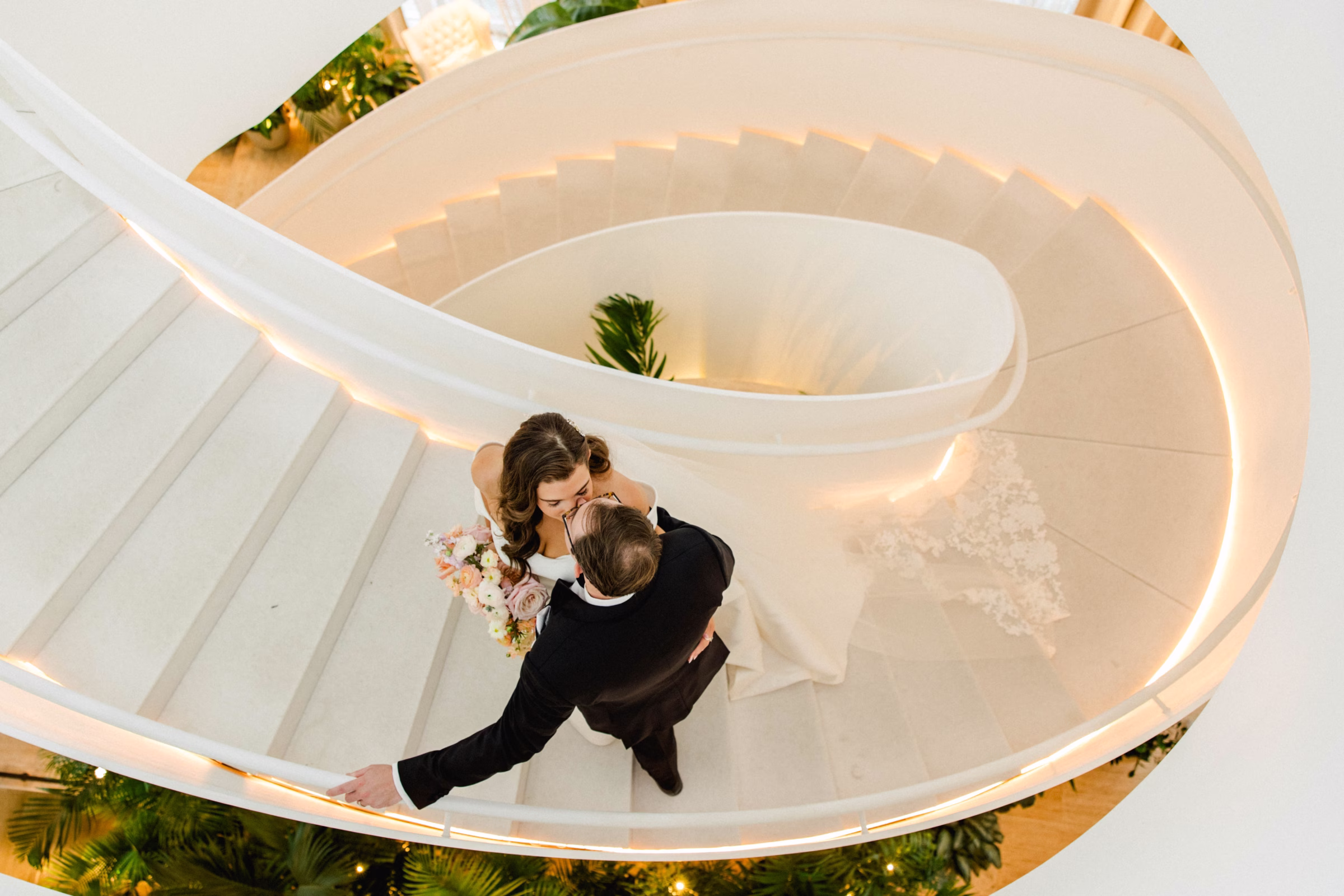 Bride and Groom Kissing Wedding Portrait on Spiral Staircase in Downtown Event Venue The Edition Hotel Tampa