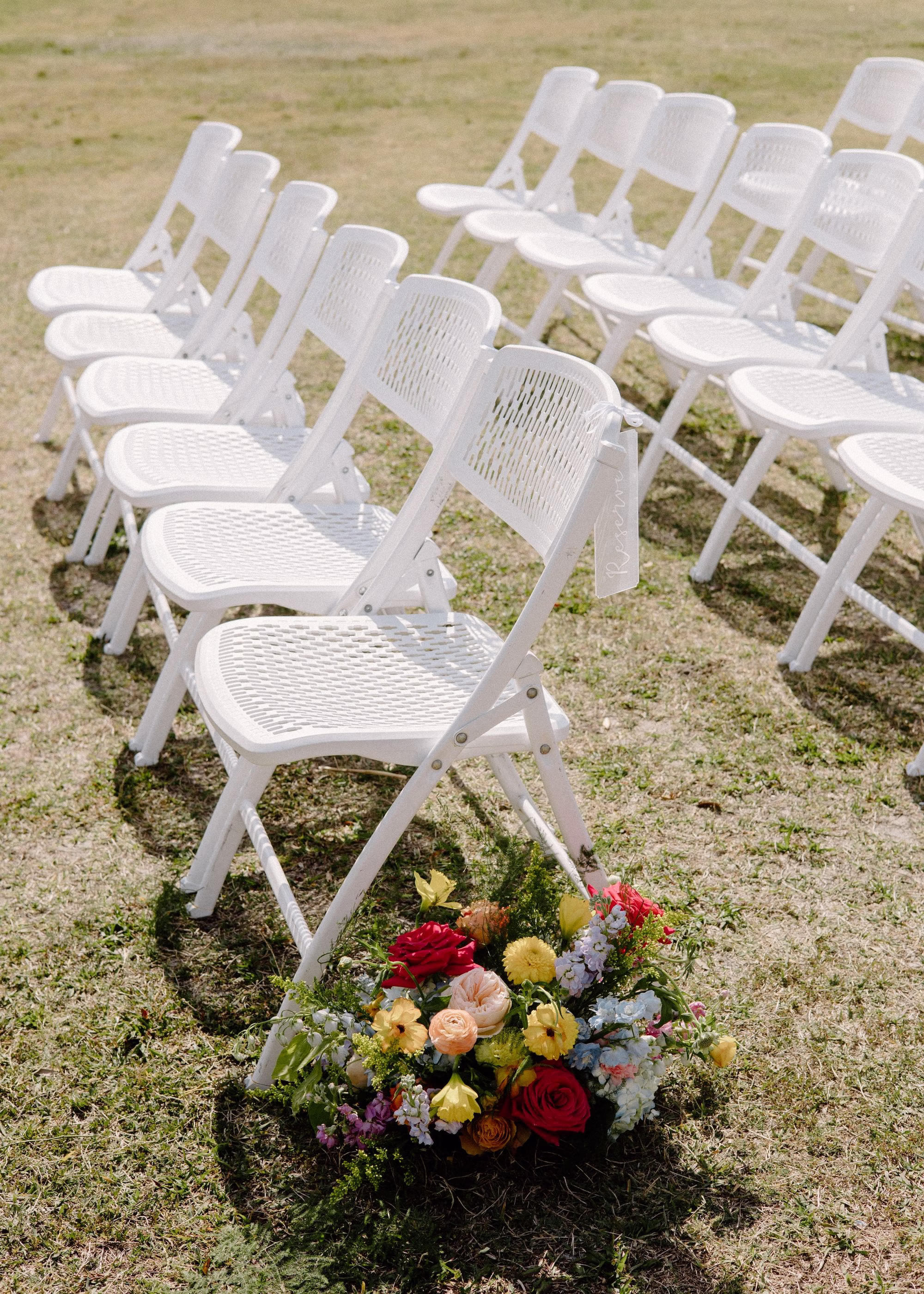 20Whimsical Pastel Spring Orange Yellow and Purple Wedding Inspiration - Whimsical, Colorful Waterfront Wedding | Tampa River Center Colorful Spring Garden Riverfront Wedding Ceremony Inspiration | White Garden Ceremony Chairs | Wedding Ceremony Aisle Decor with Spring Pastel Orange, Yellow, Lavender, Blush Floral Ideas | Planner Wilder Mind Events | Venue Tampa River Center