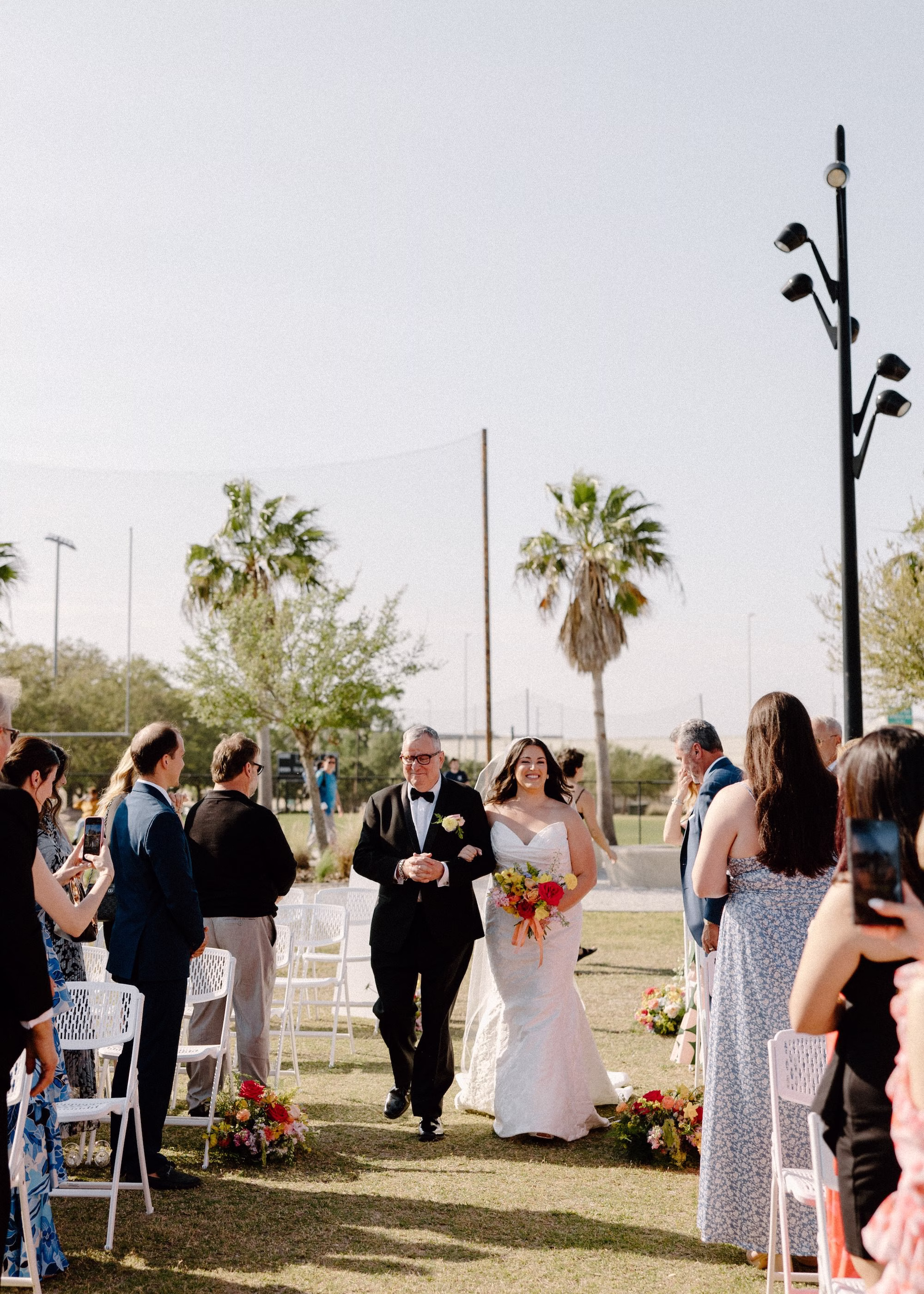 25Whimsical Pastel Spring Orange Yellow and Purple Wedding Inspiration - Whimsical, Colorful Waterfront Wedding | Tampa River Center Bride and Father Walking Down Wedding Ceremony Aisle