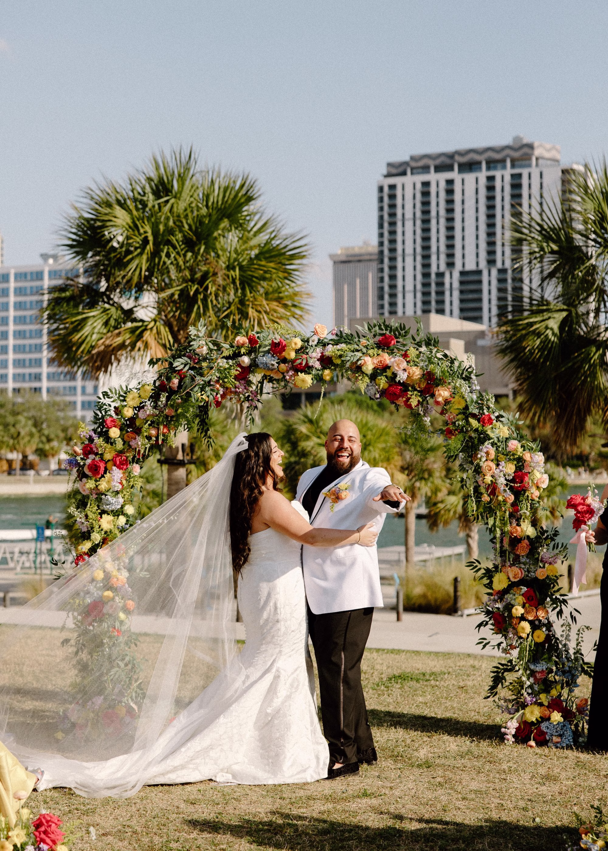 27Whimsical Pastel Spring Orange Yellow and Purple Wedding Inspiration - Whimsical, Colorful Waterfront Wedding | Tampa River Center Bride and Groom Wedding Ceremony Vow Exchange Wedding Portrait | Colorful Spring Garden Riverfront Wedding Ceremony Inspiration | Rounded Floral Wedding Ceremony Altar Arch with Spring Pastel Orange, Yellow, Lavender, Blush Floral Ideas | Planner Wilder Mind Events | Clearwater Officiant Laurie Chandler Celebrant