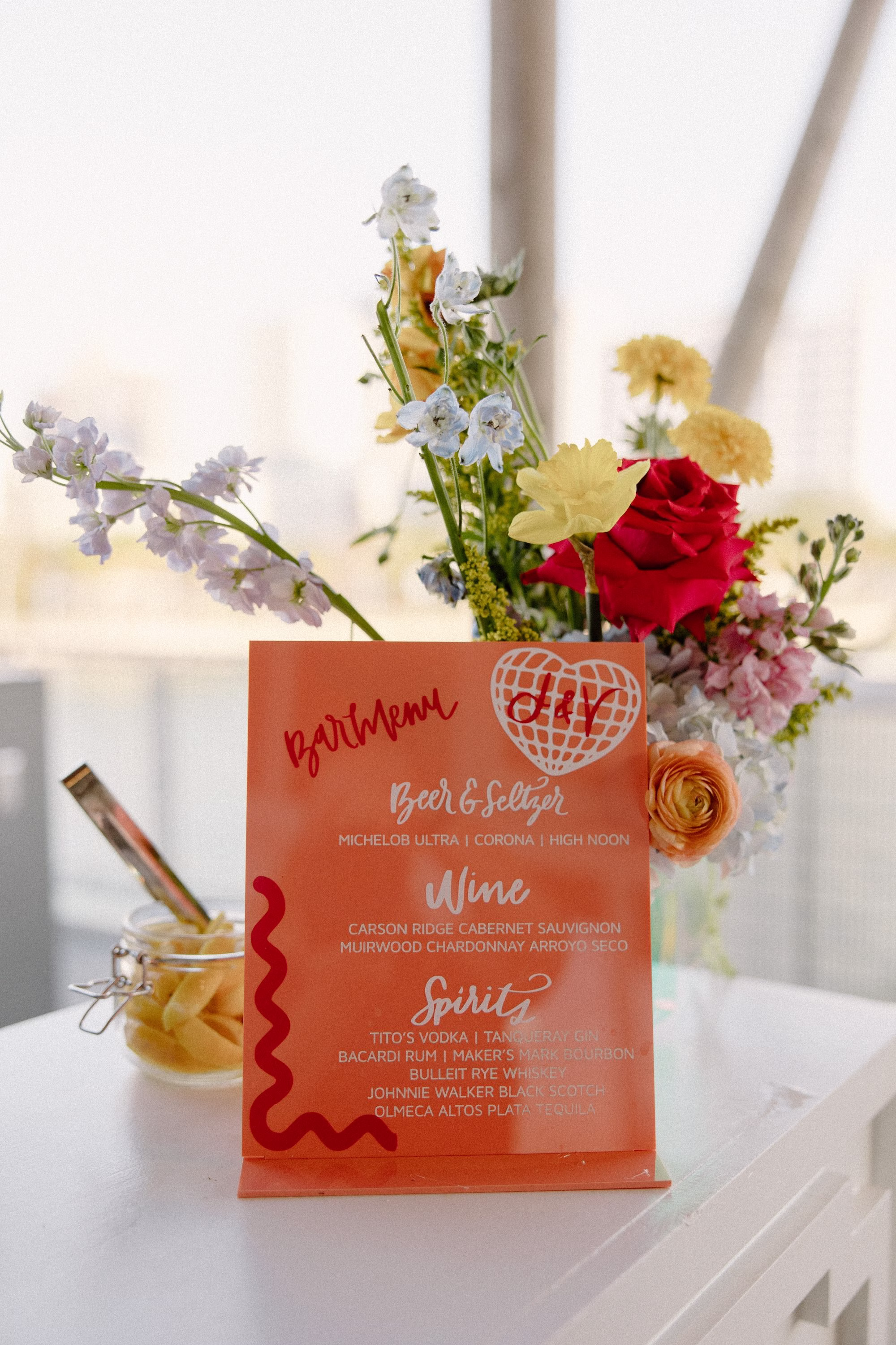 42Whimsical Pastel Spring Orange Yellow and Purple Wedding Inspiration - Whimsical, Colorful Waterfront Wedding | Tampa River Center Modern Colorful Orange, Pink, Maroon Custom Wedding Reception Bar Drink Sign Decor Ideas | Whimsical Spring Pastel Yellow, Red, Pink, Orange, Blue Floral Arrangement Wedding Reception Decor Inspiration | Tampa Bay Planner Wilder Mind Events | Florida Sign Designer madWOLFE