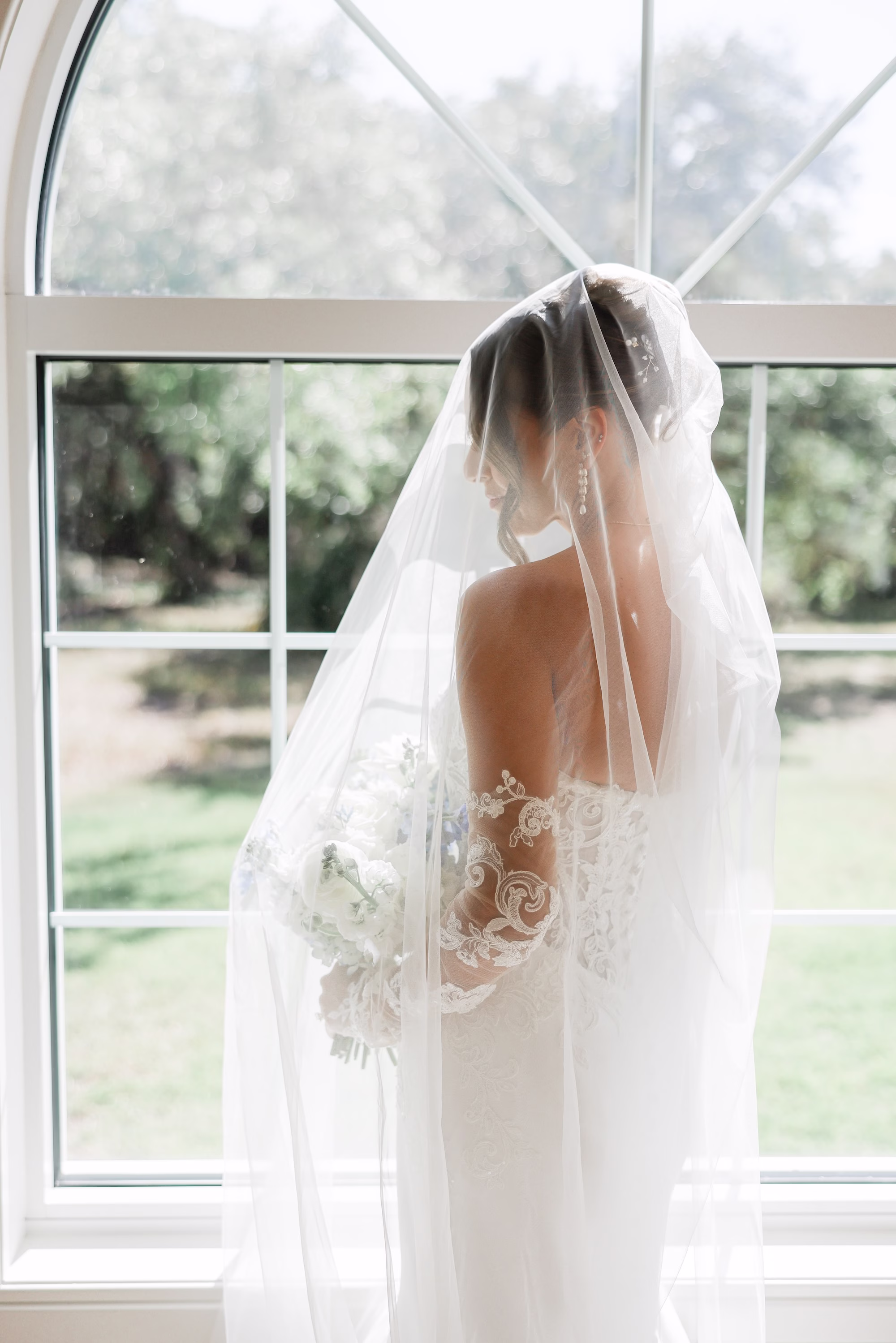 Bride Wedding Portrait | Elegant Strapless The Dessy Group White Wedding Gown with Lace Bodice and Sleeves Ideas | Soft Curled Bun Bridal Hair with Traditional Veil Inspiration | Clearwater Photographer Lifelong Photography Studio | Tampa Boutique Truly Forever Bridal | Ybor Hair and Makeup Artist Adore Bridal Hair and Makeup | Content Creator Behind The Vows