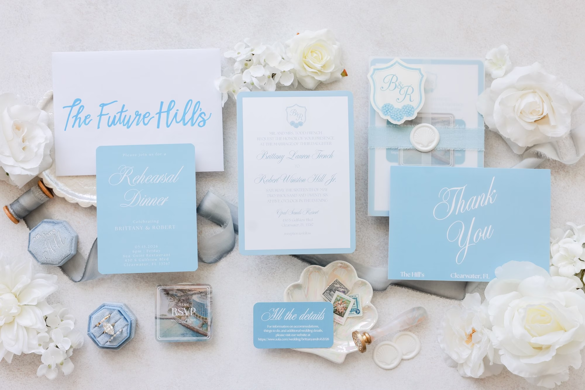 1Elegant Light Blue Coastal Florida Wedding Ideas - Elegant Blue Modern Coastal Wedding | Opal Sands Clearwater Beach Light Blue and White Wedding Invitation Suite Flat Lay with Monogram Crest, Blue Velvet Ring Boxes and White Roses Ideas