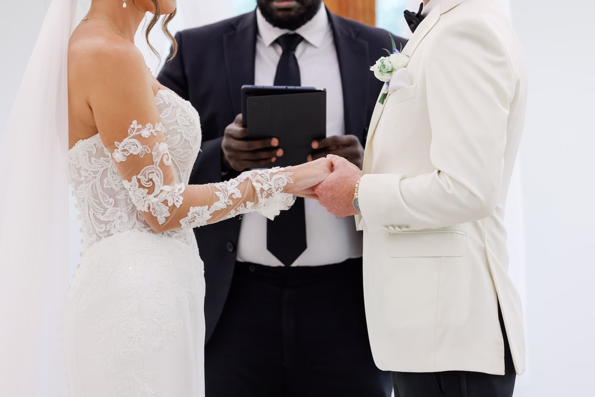 Bride and Groom Wedding Ceremony Vow Exchange Wedding Portrait | Elegant Strapless The Dessy Group White Wedding Gown with Lace Bodice and Sleeves Ideas | Clearwater Photographer Lifelong Photography Studio | Tampa Boutique Truly Forever Bridal | Content Creator Behind The Vows