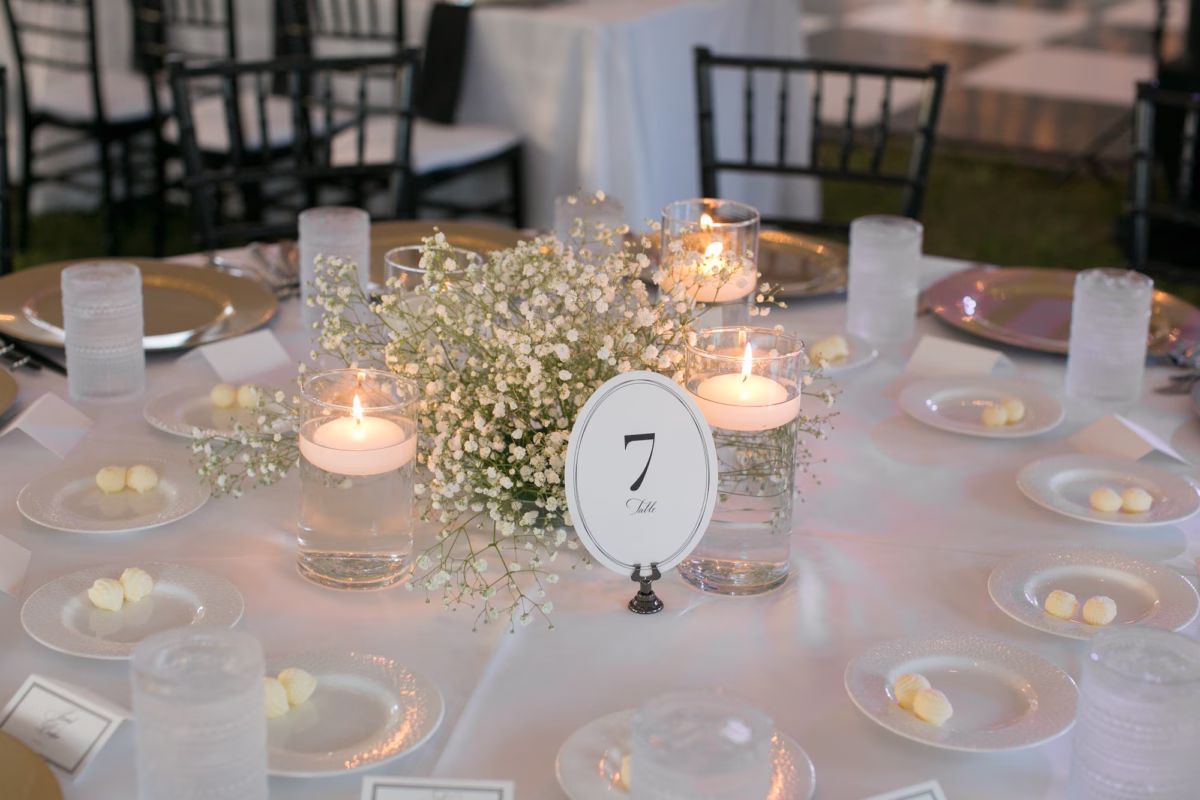 25Classic Black and White Wedding Ideas - Classic Black and White Clearwater Wedding | Harborside Chapel & The Fenway Timeless White and Black Intimate Wedding Reception Decor Inspiration | Lush White Baby's Breath Floral Centerpiece with Floating Tea Candles Tablescape Decor Ideas | White and Black Table Number Decor Inspiration | Largo Rental Service Gabro Event Services