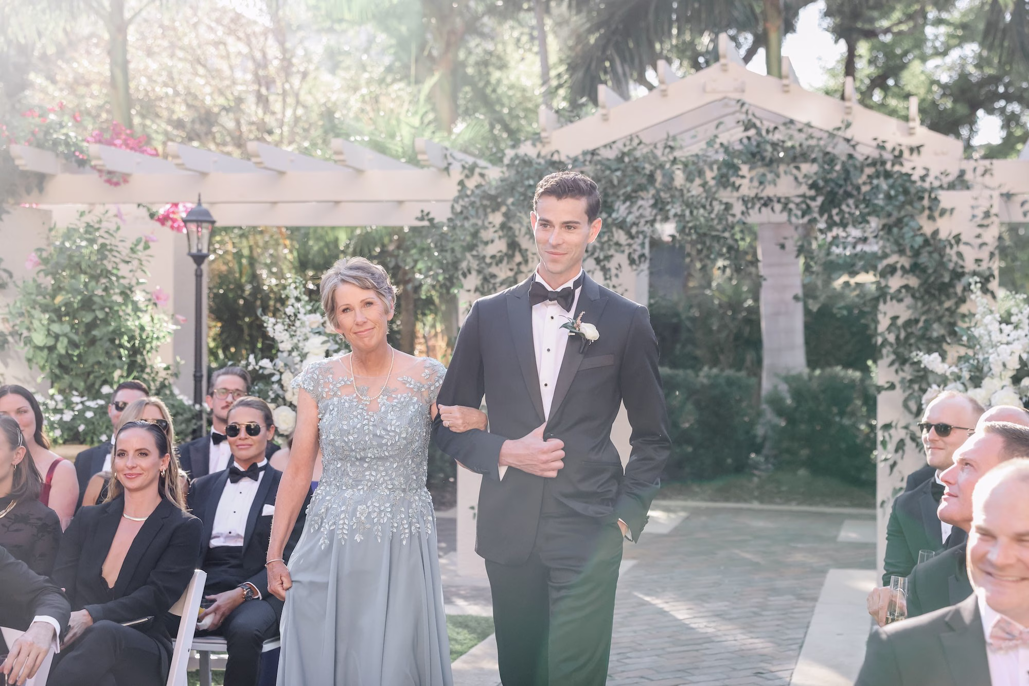 25Timeless White and Green Wedding Inspiration - Chic Blush and White St. Pete Garden Wedding | The Vinoy Groom and Mother Walking Down Wedding Aisle