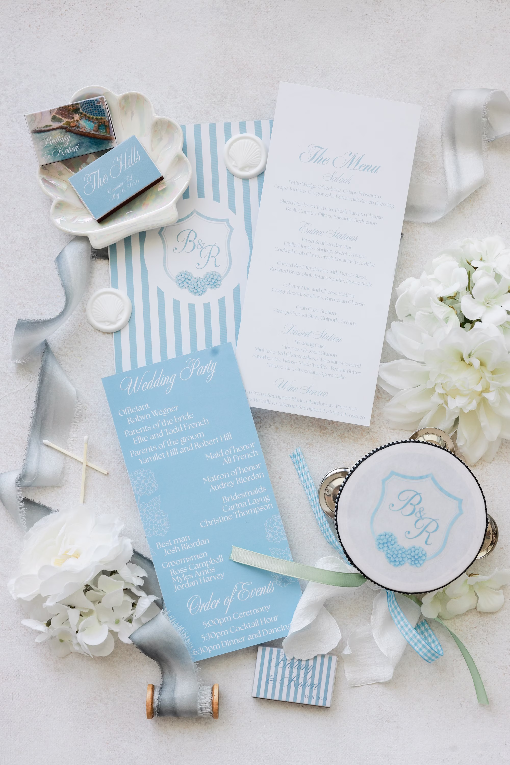 2Elegant Light Blue Coastal Florida Wedding Ideas - Elegant Blue Modern Coastal Wedding | Opal Sands Clearwater Beach Light Blue Striped Wedding Menu and Program Flat Lay with Monogram Crest Cocktail Napkin and White Hydrangea Ideas
