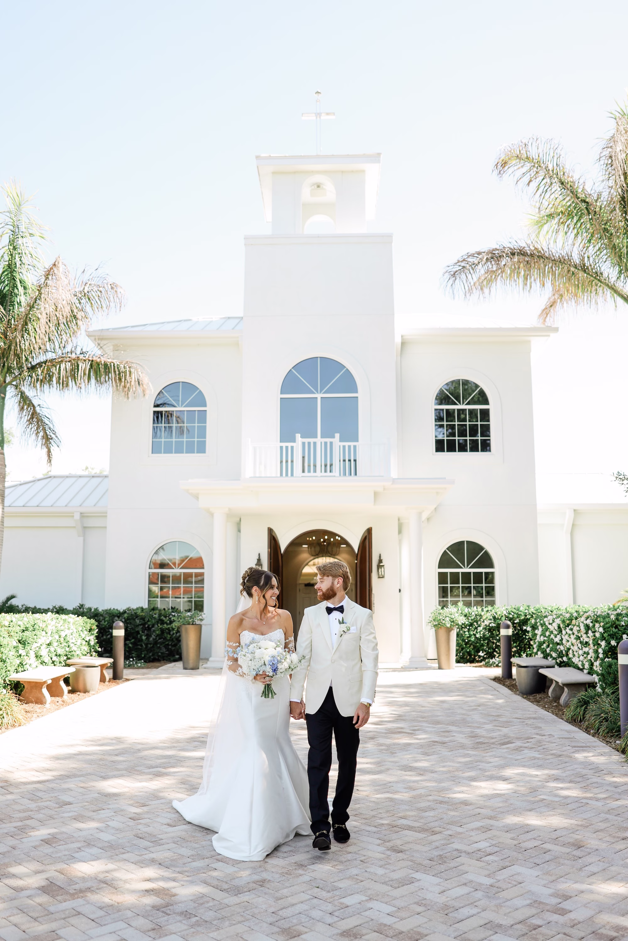 Bride and Groom Outdoor Spring Wedding Portrait | Elegant Strapless The Dessy Group White Wedding Gown with Lace Bodice and Sleeves Ideas | Soft Curled Bun Bridal Hair with Traditional Veil Inspiration | Clearwater Photographer Lifelong Photography Studio | Tampa Boutique Truly Forever Bridal | Ybor Hair and Makeup Artist Adore Bridal Hair and Makeup | Content Creator Behind The Vows | Ceremony Venue Harborside Chapel