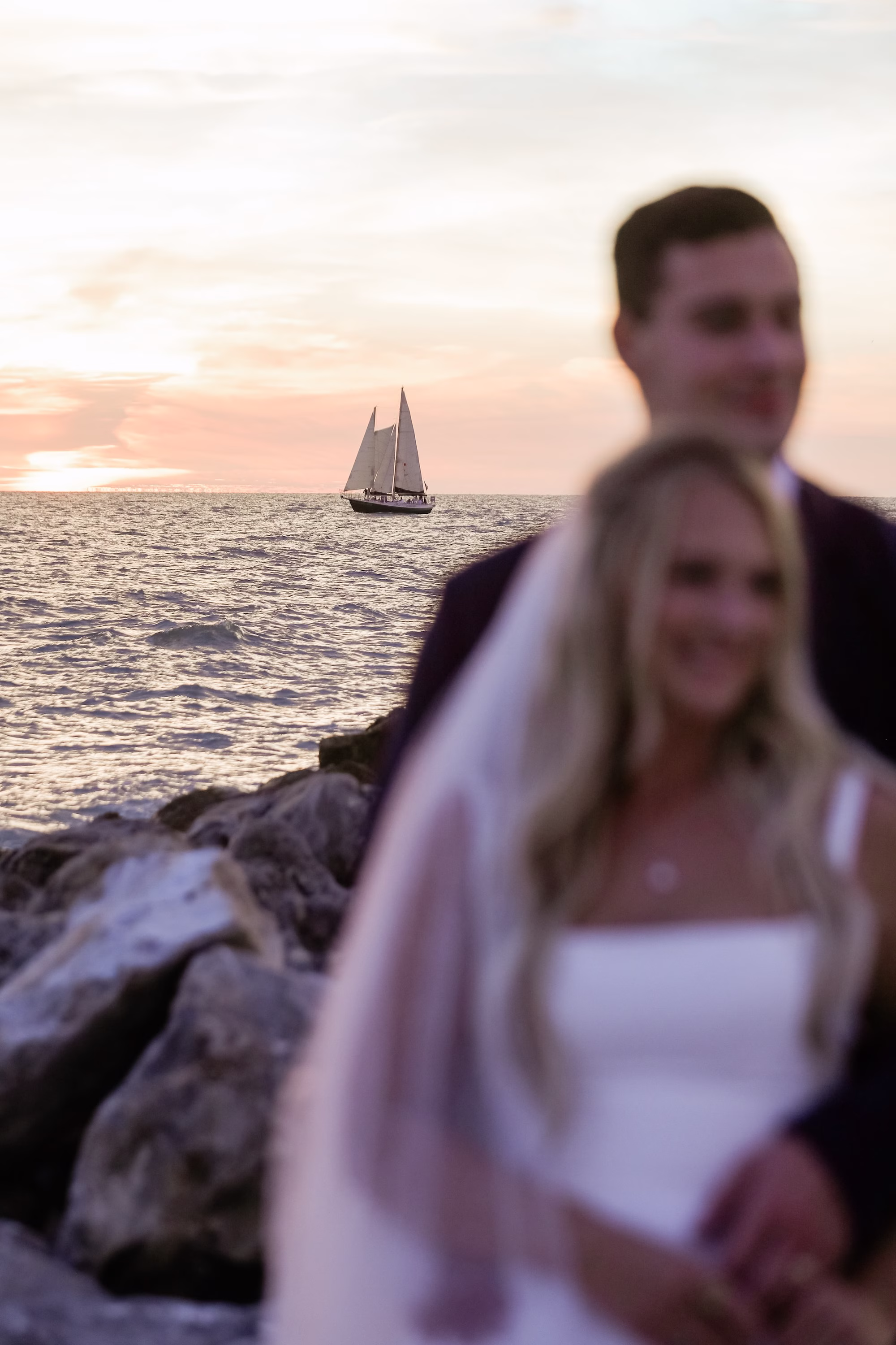 32Elegant Light Blue Coastal Florida Wedding Ideas Clearwater Venue Opal Sands - Elegant Blue Modern Coastal Wedding | Opal Sands Clearwater Beach Bride and Groom Golden Hour Beach Wedding Portrait with Sailboat on the Gulf Behind Them | Tampa Bay Photography Lifelong Photography Studio | Venue Opal Sands Resort