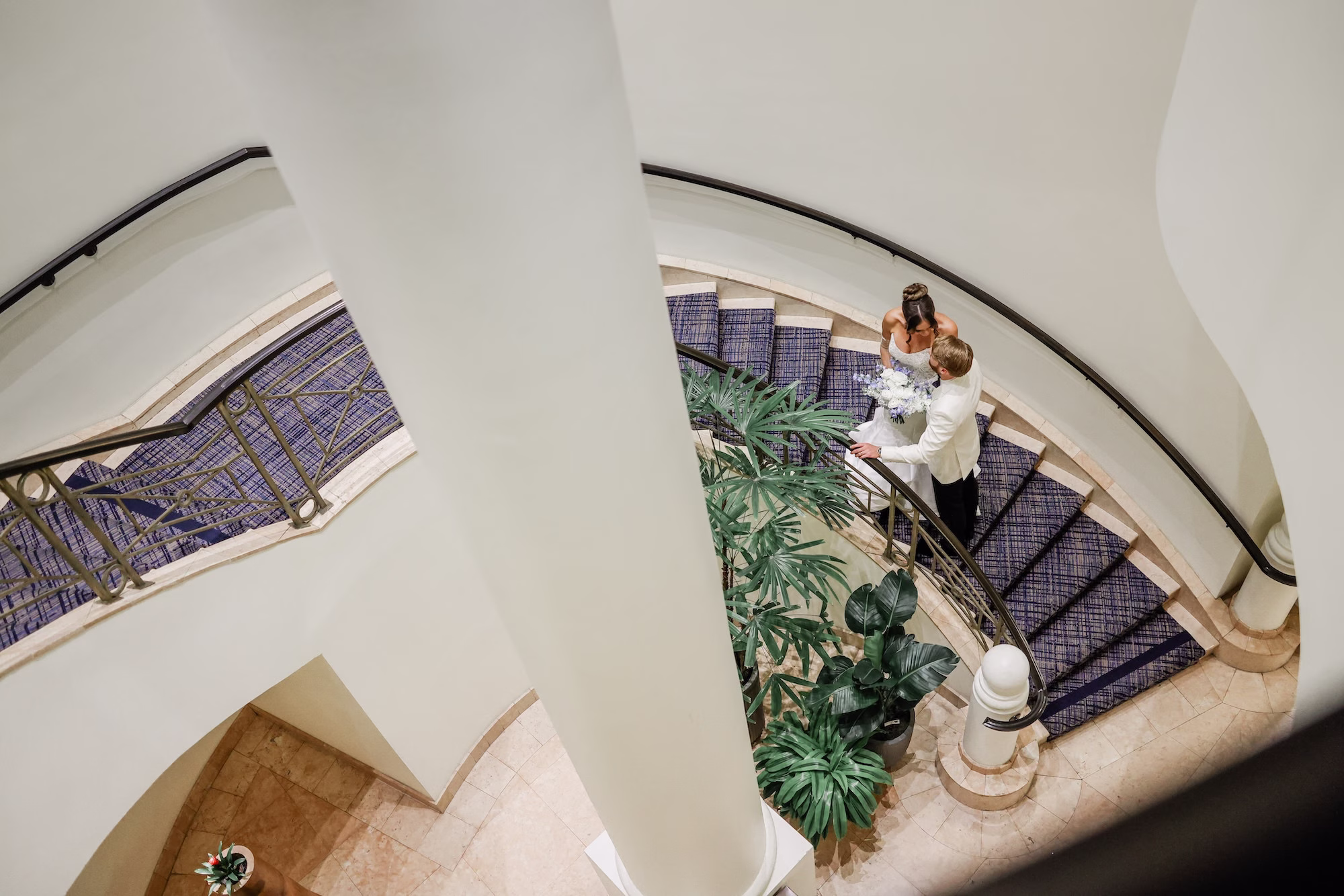 Bride and Groom on Spiral Stair Case of Wedding Venue Grand Hyatt Tampa Bay Wedding Portrait | Clearwater Photographer Lifelong Photography Studio | Content Creator Behind The Vows
