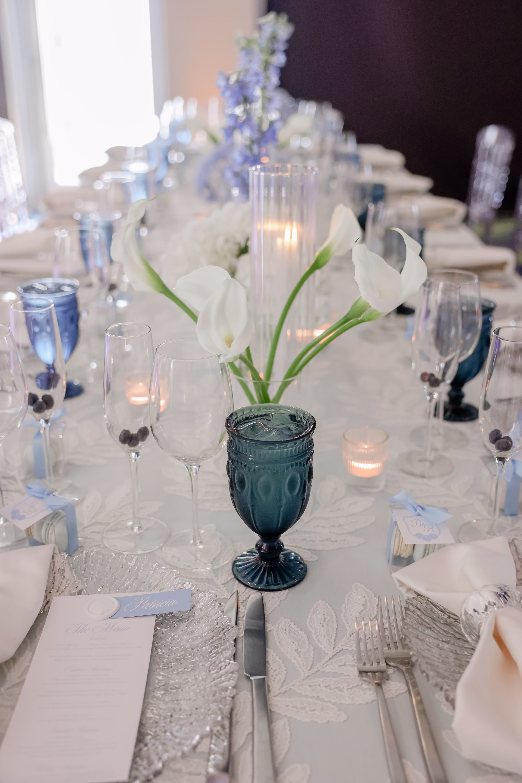 34Elegant Light Blue Coastal Florida Wedding Ideas - Elegant Blue Modern Coastal Wedding | Opal Sands Clearwater Beach White Calla Lily and Blue Delphinium Centerpiece with Navy Blue Water Goblets and Taper Candles Wedding Reception Ideas | Clearwater Beach Gabro Event Rentals