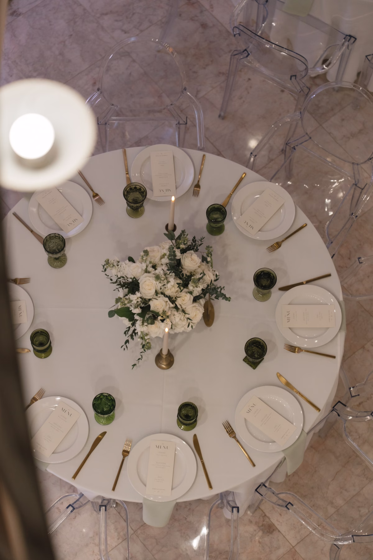 Luxurious Ballroom Wedding Reception | Clear Acrylic Ghost Ceremony Chairs Ideas | Lush Centerpieces of White Roses and Hydrangeas with White Taper Candles Reception Decor Inspiration | Gold Flatware with White Chargers and Gold Rim Tablescape Decor Ideas | Tarpon Springs Event Venue Whitehurst Gallery | Treasure Island Caterer Amici's Catered Cuisine
