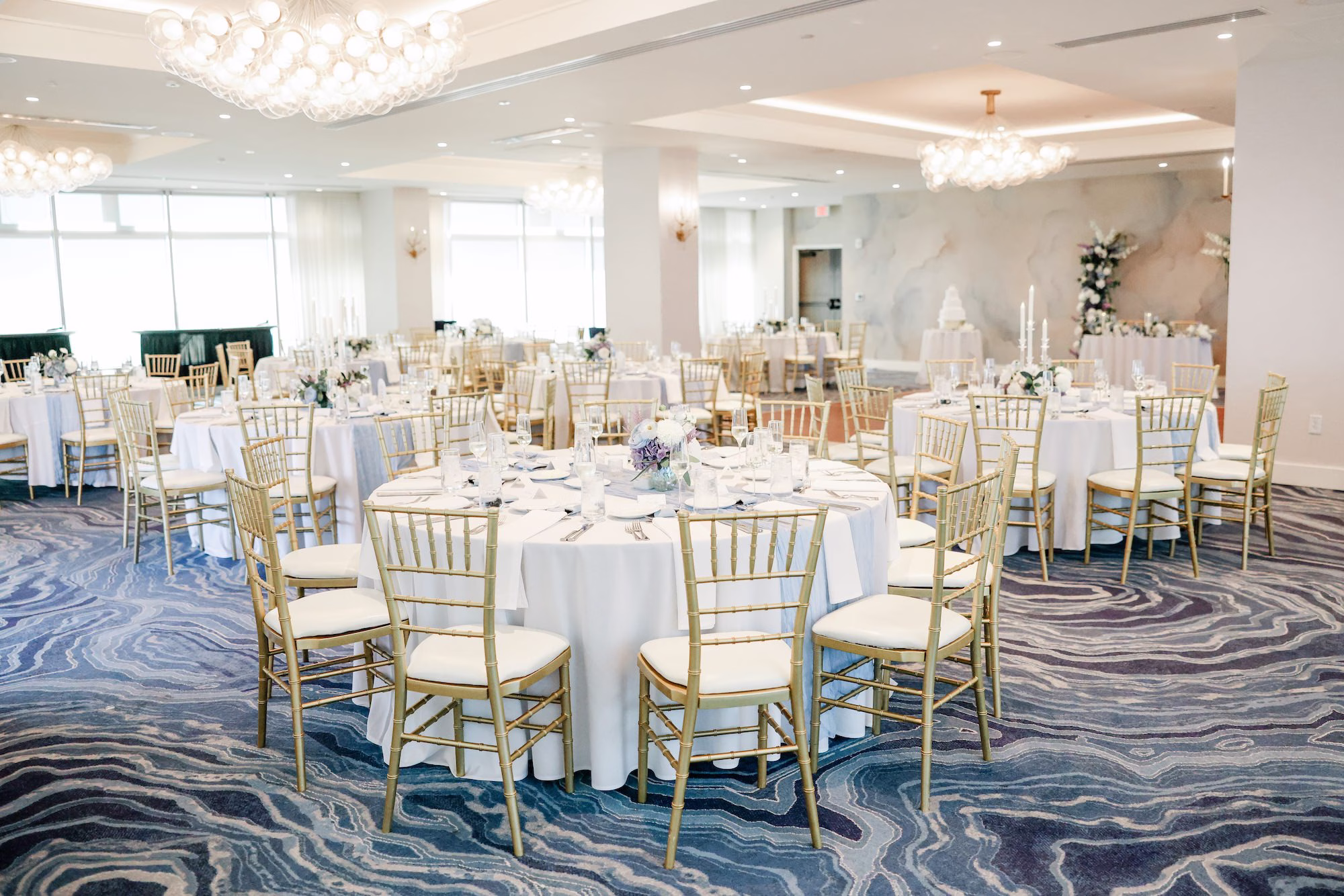 Luxurious Ballroom Coastal Wedding Reception | Modern Gold Chiavari Chairs | Romantic Taper Candle Centerpieces with Lush White and Blue Hydrangeas and Roses Flower Arrangement Ideas | Wedding Venue Grand Hyatt Tampa Bay