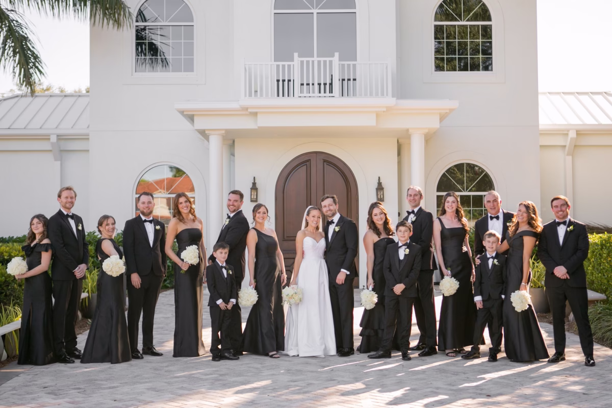 9Classic Black and White Wedding Ideas Tampa Bay Venue Harborside Chapel - Classic Black and White Clearwater Wedding | Harborside Chapel & The Fenway Bride and Groom with Wedding Party Classic Black and White Wedding Portrait | Mismatched Black Bridesmaid Dresses Inspiration | Timeless Black and White Groom Tuxedo Ideas | Simple Monochromatic White Rose Bouquet Inspiration | Tampa Bay Photographer Carrie Wildes Photography Art and Design | Safety Harbor Event Venue Harborside Chapel