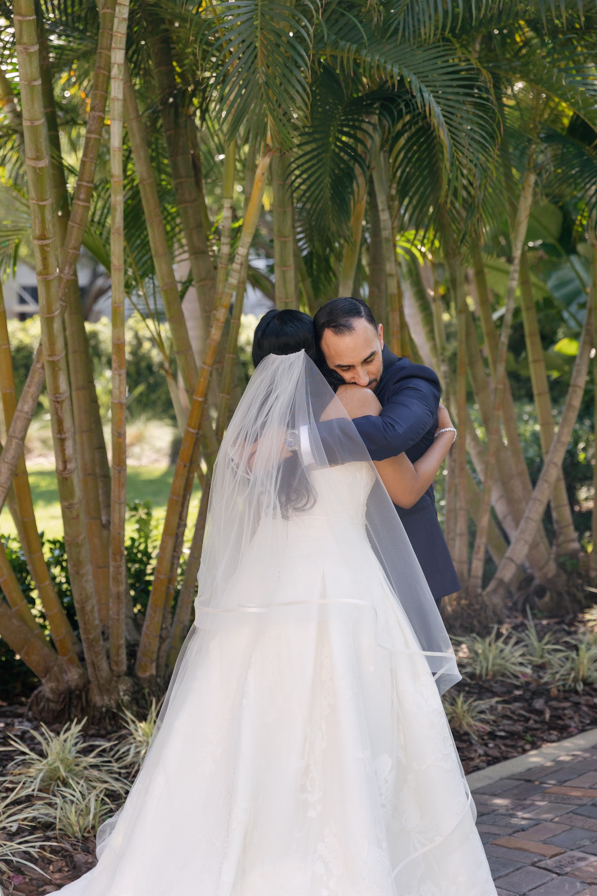 Bride and Groom First Look Embrace Wedding Portrait in Tropical Palm Garden