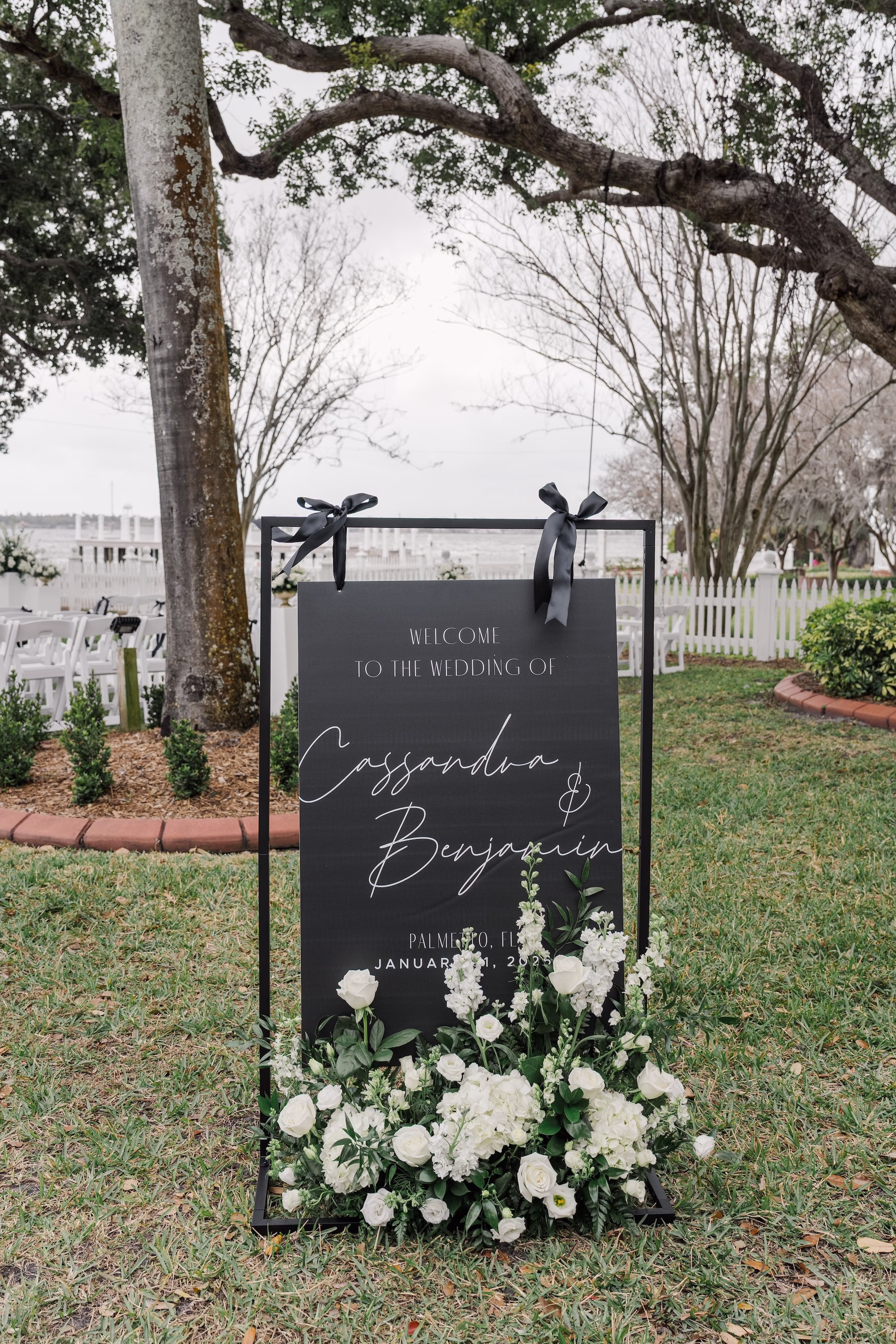 Black Acrylic Wedding Ceremony Welcome Sign with Black Ribbon Bows and White Rose Floral Arrangement Decor Ideas