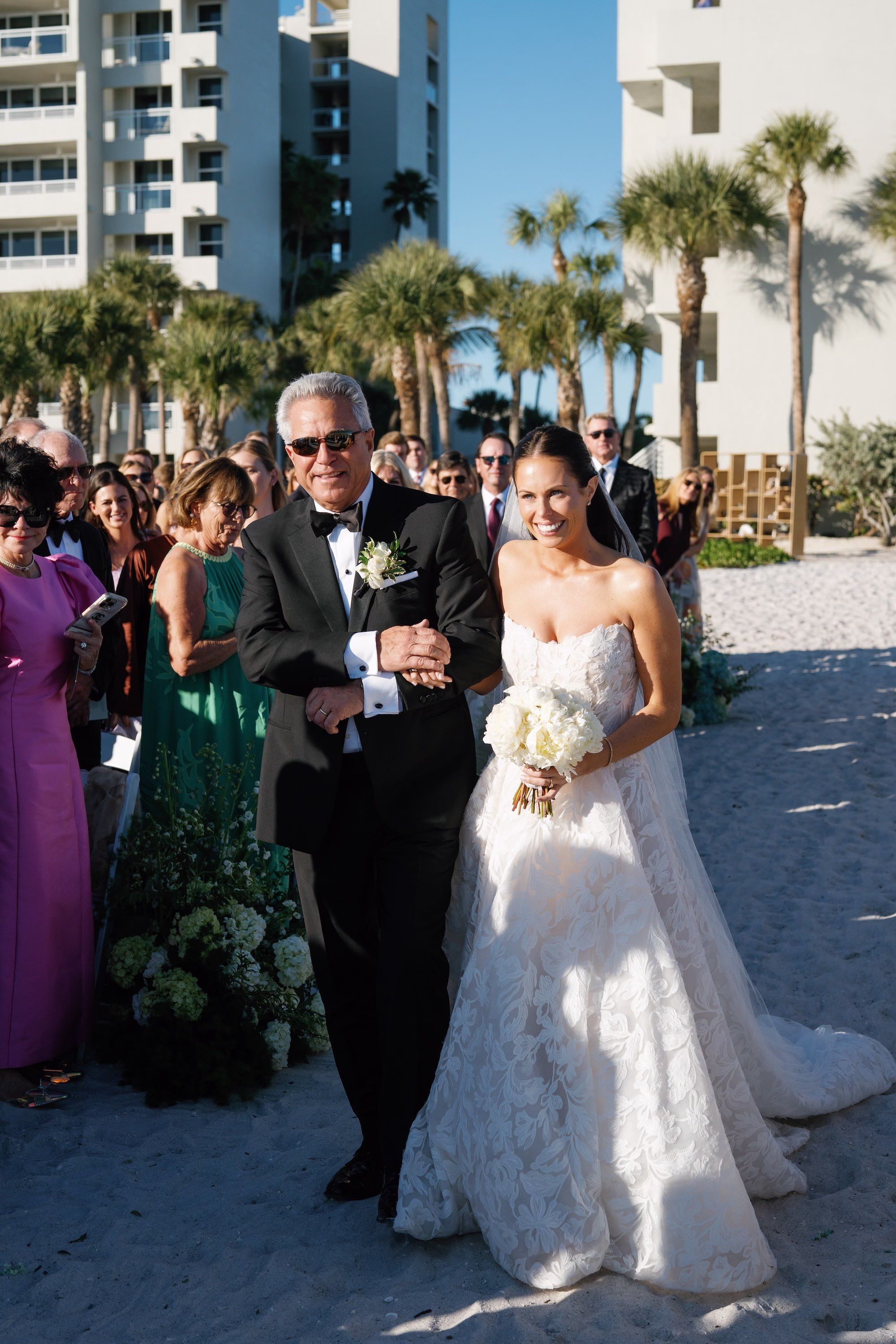 16Coastal Nancy Meyers Inspired Florida Beach Wedding - Coastal Blue, White, and Green Sarasota Wedding | The Resort at Longboat Key Club Bride and Father Walking Down Sand Aisle Beach Wedding Ceremony with White Rose Bouquet