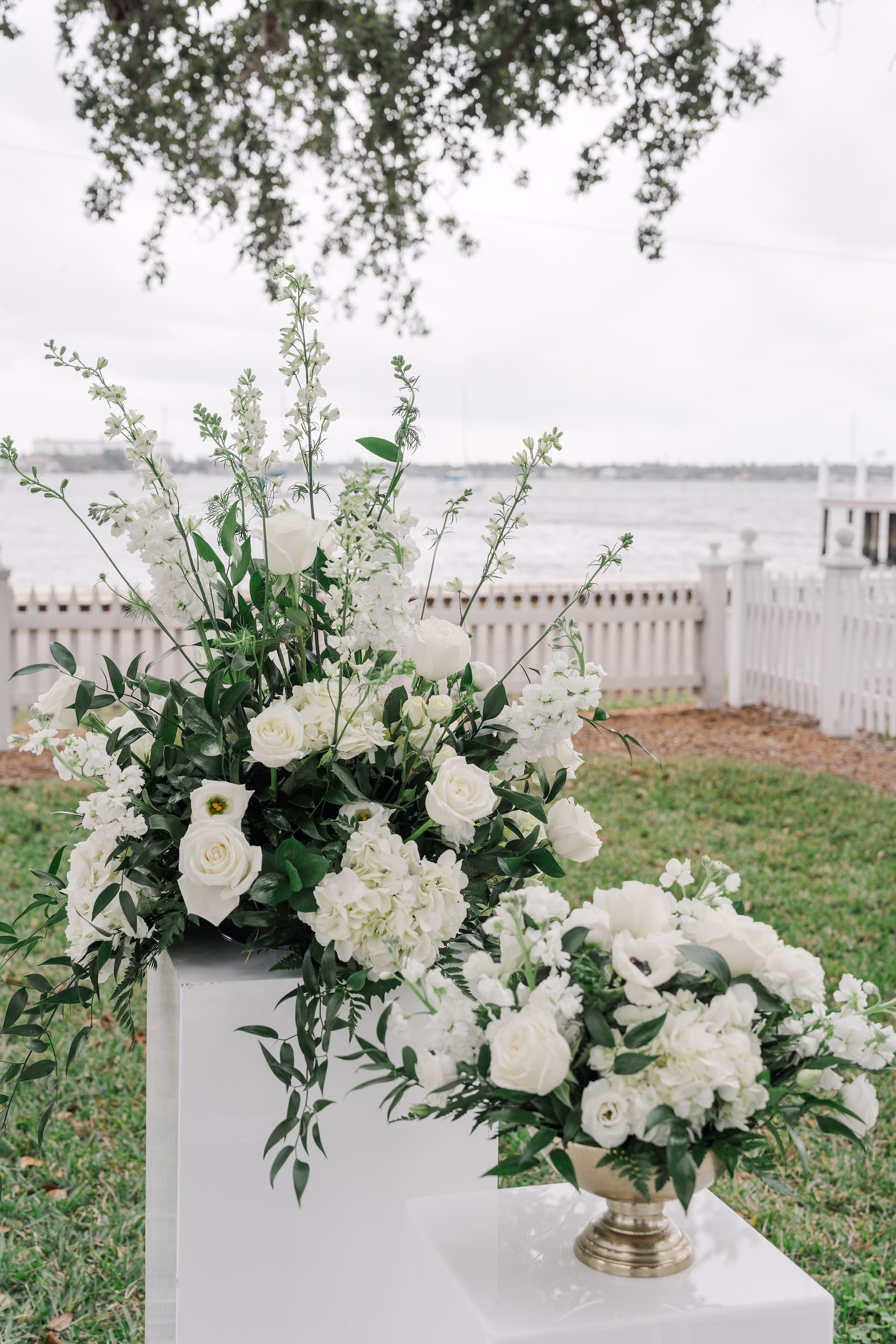 White Rose, Hydrangea and Stock Wedding Ceremony Floral Arrangement on White Pedestal with Riverfront View Ideas