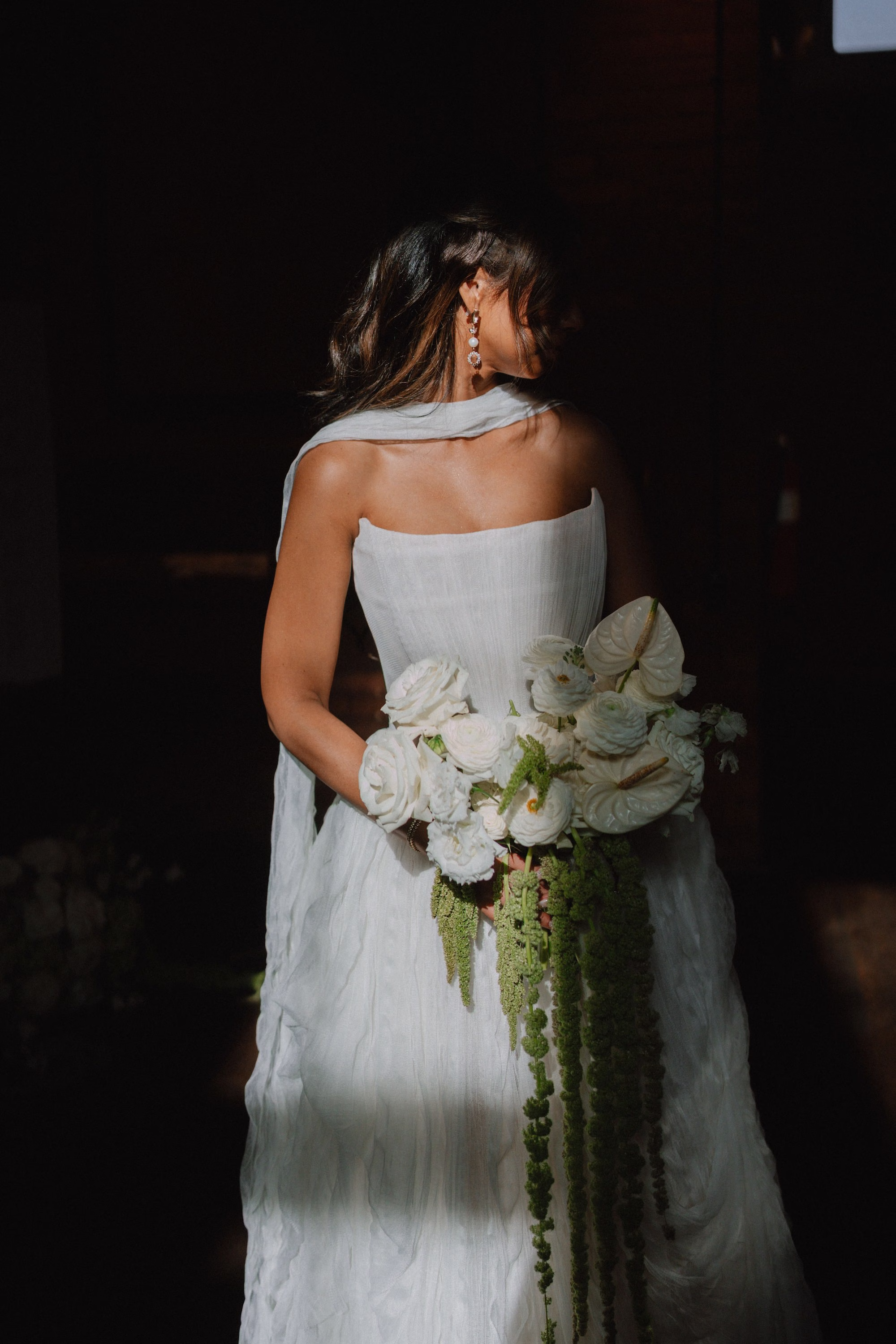 19Classic Modern Black and White Wedding Ideas - Modern Black and Ivory Ybor City Wedding | J.C. Newman Cigar Co. Bride Holding White Rose, Anthurium and Hanging Amaranthus Bouquet Wedding Portrait from Behind with Draped Neck Scarf