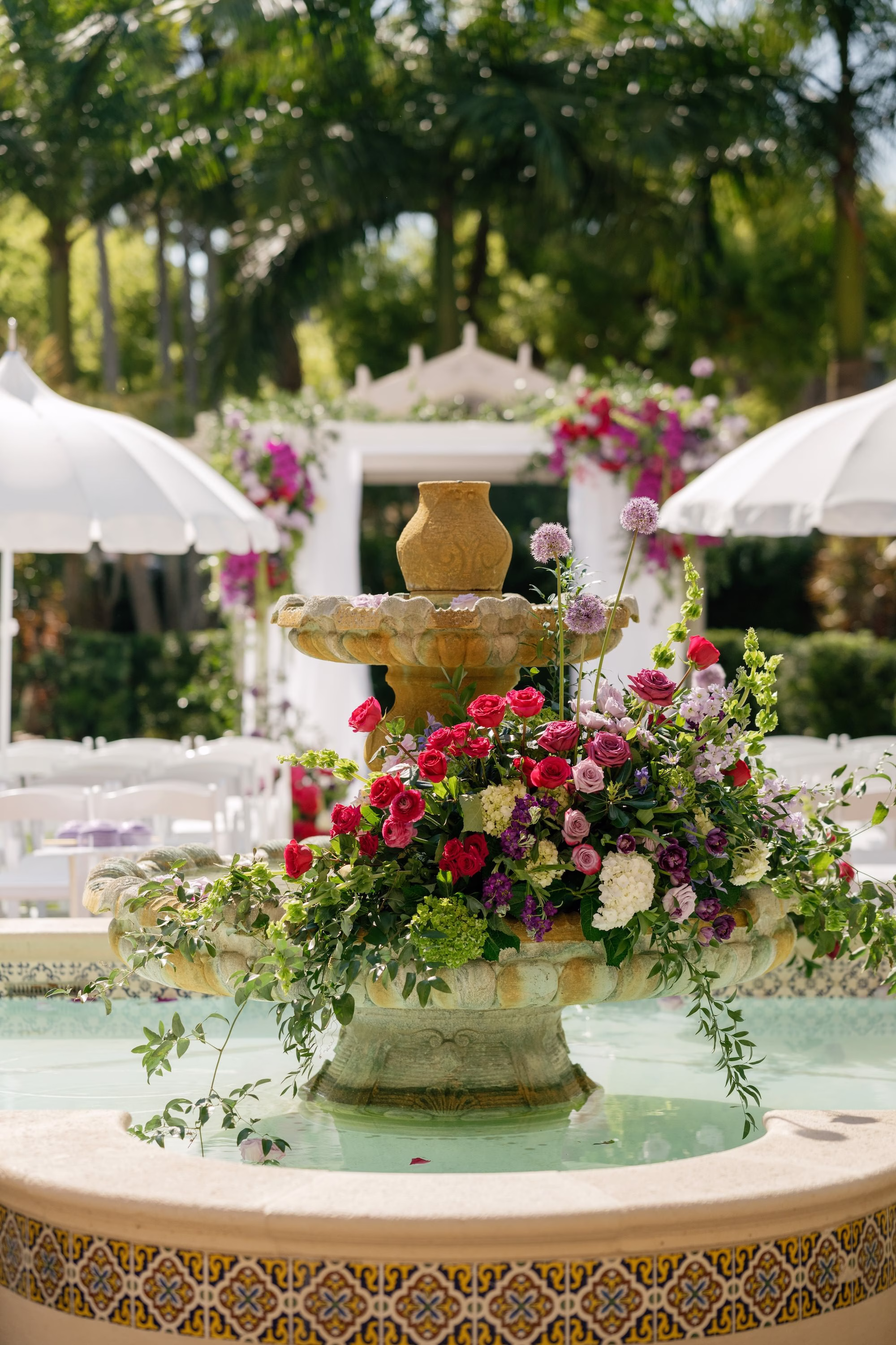 Vibrant Pink, Red and Purple Rose and Allium Floral Arrangement on Tiered Stone Fountain Wedding Ceremony Decor Ideas | St. Pete Florist Bruce Wayne Florals