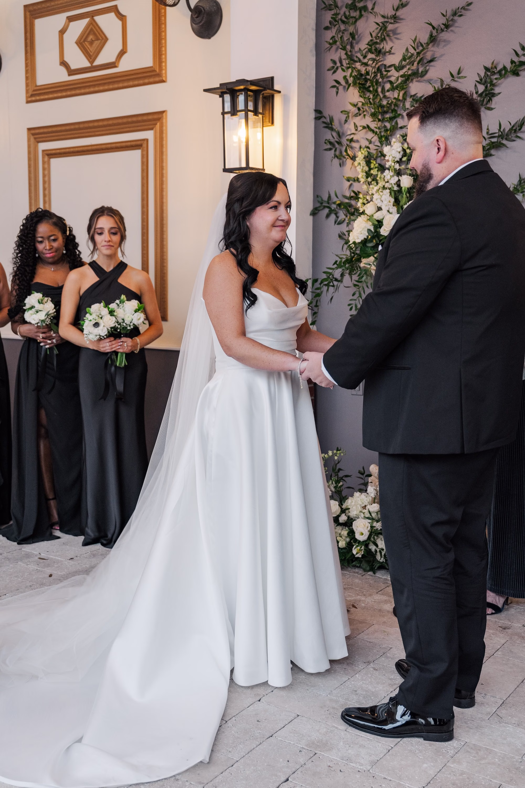 Bride and Groom Wedding Ceremony Vow Exchange Wedding Portrait with Bridesmaids in Black Dresses