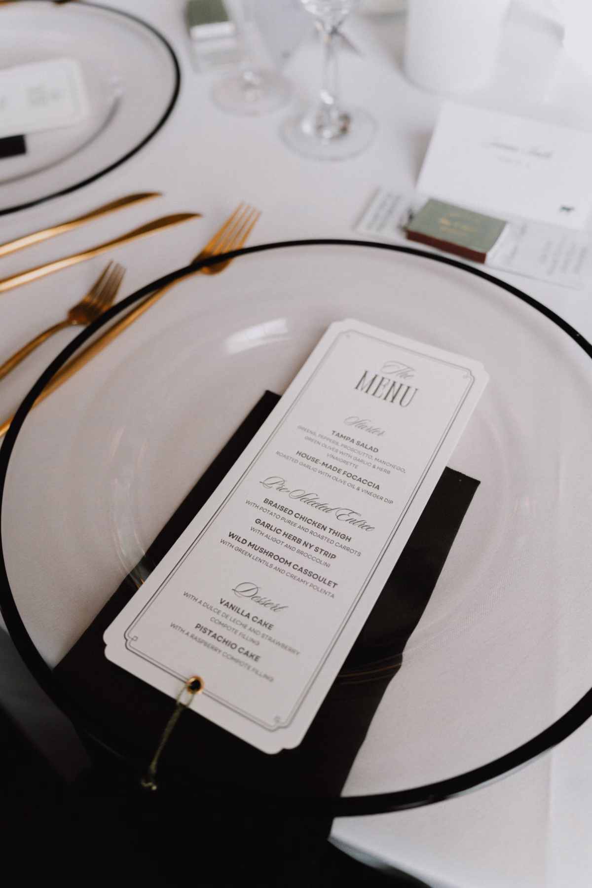 25Classic Modern Black and White Wedding Ideas - Modern Black and Ivory Ybor City Wedding | J.C. Newman Cigar Co. Modern Black Rimmed Charger with Black Napkin, Gold Flatware and Black and White Wedding Menu Card Place Setting Ideas