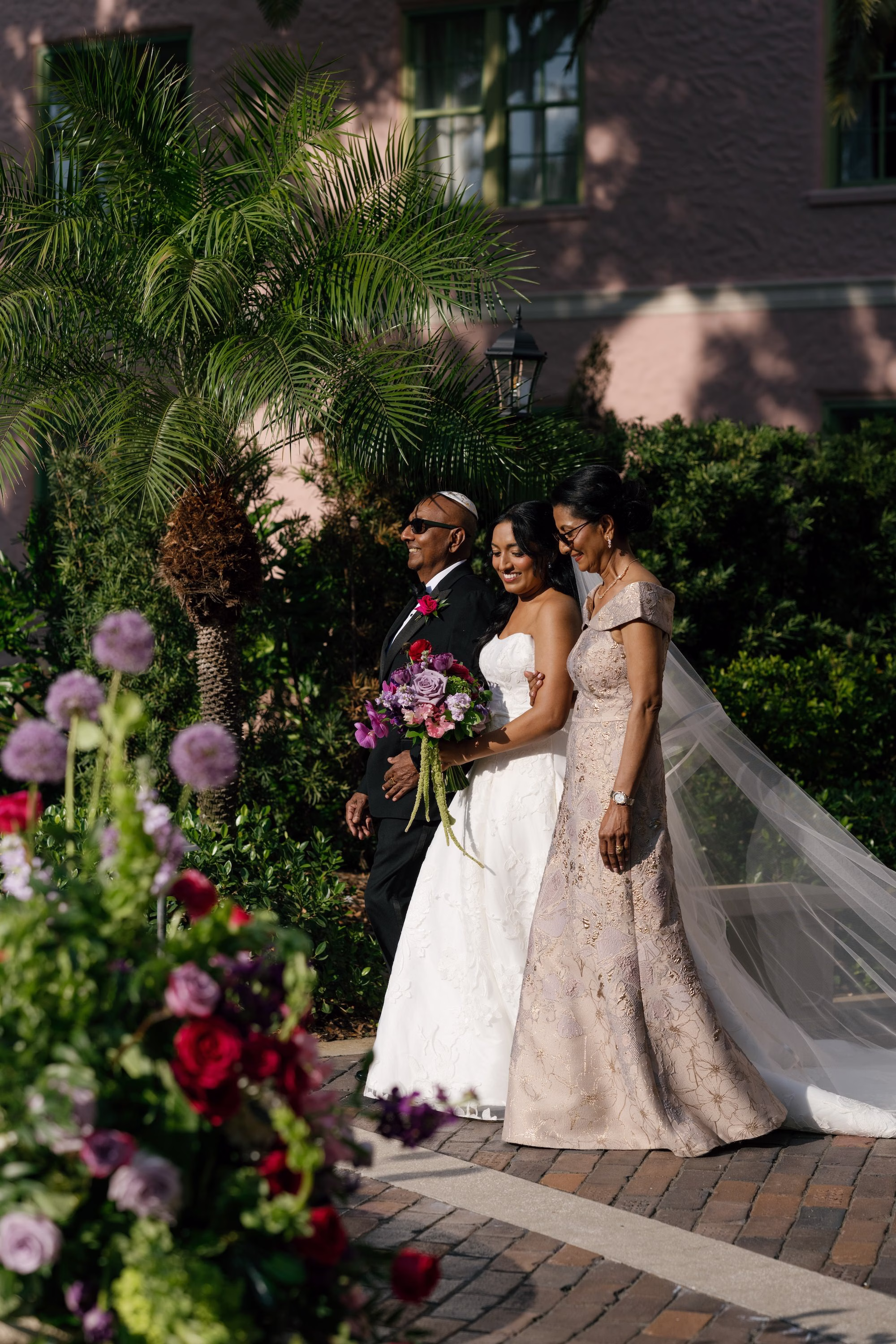 Bride Walking Down Wedding Ceremony Aisle with Mother and Father