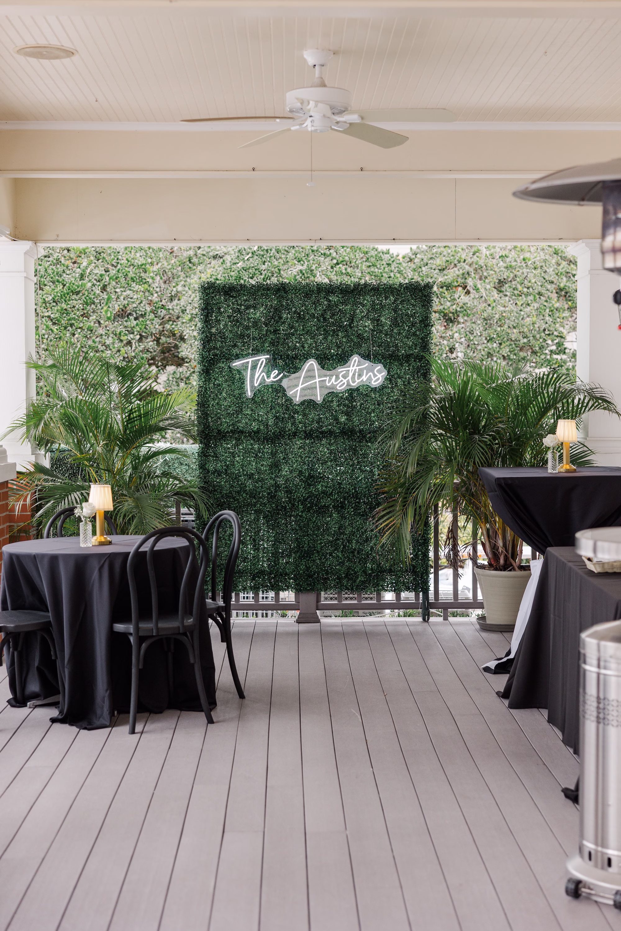 Greenery Wall with The Austins Custom Neon Sign and Black Linen Cocktail Tables Wedding Cocktail Hour Decor Ideas | Palmetto Rentals Kate Ryan Event Rentals
