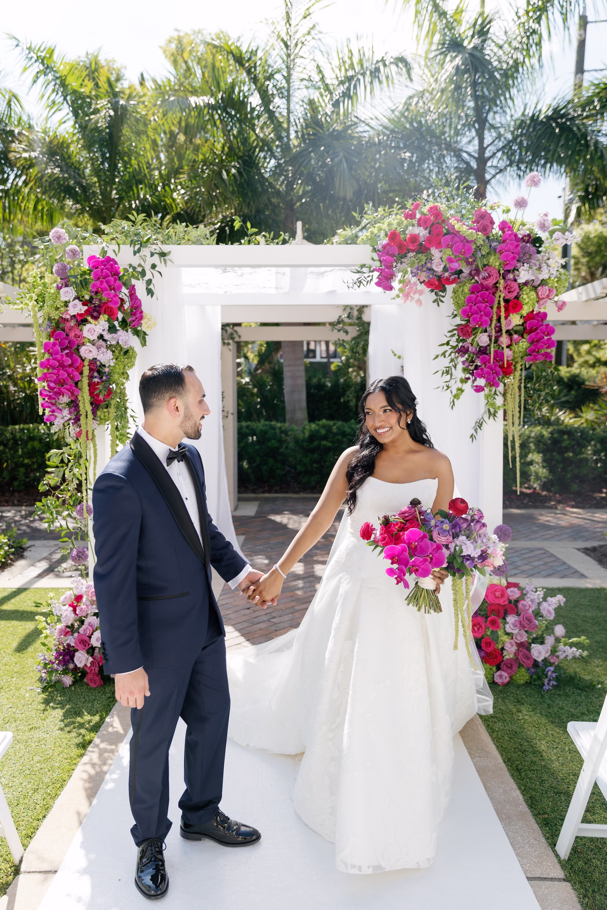 Bride and Groom Wedding Ceremony Recessional Walking Up Aisle from Floral Chuppah | St. Pete Florist Bruce Wayne Florals | Planner Parties A' La Carte