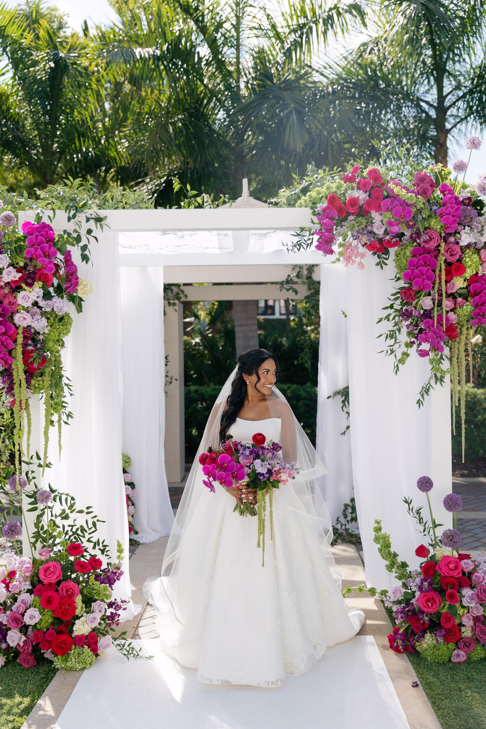 Bride in White Strapless Ballgown with Vibrant Pink Orchid Bouquet Under Fuchsia Floral Chuppah Wedding Portrait | St. Pete Florist Bruce Wayne Florals
