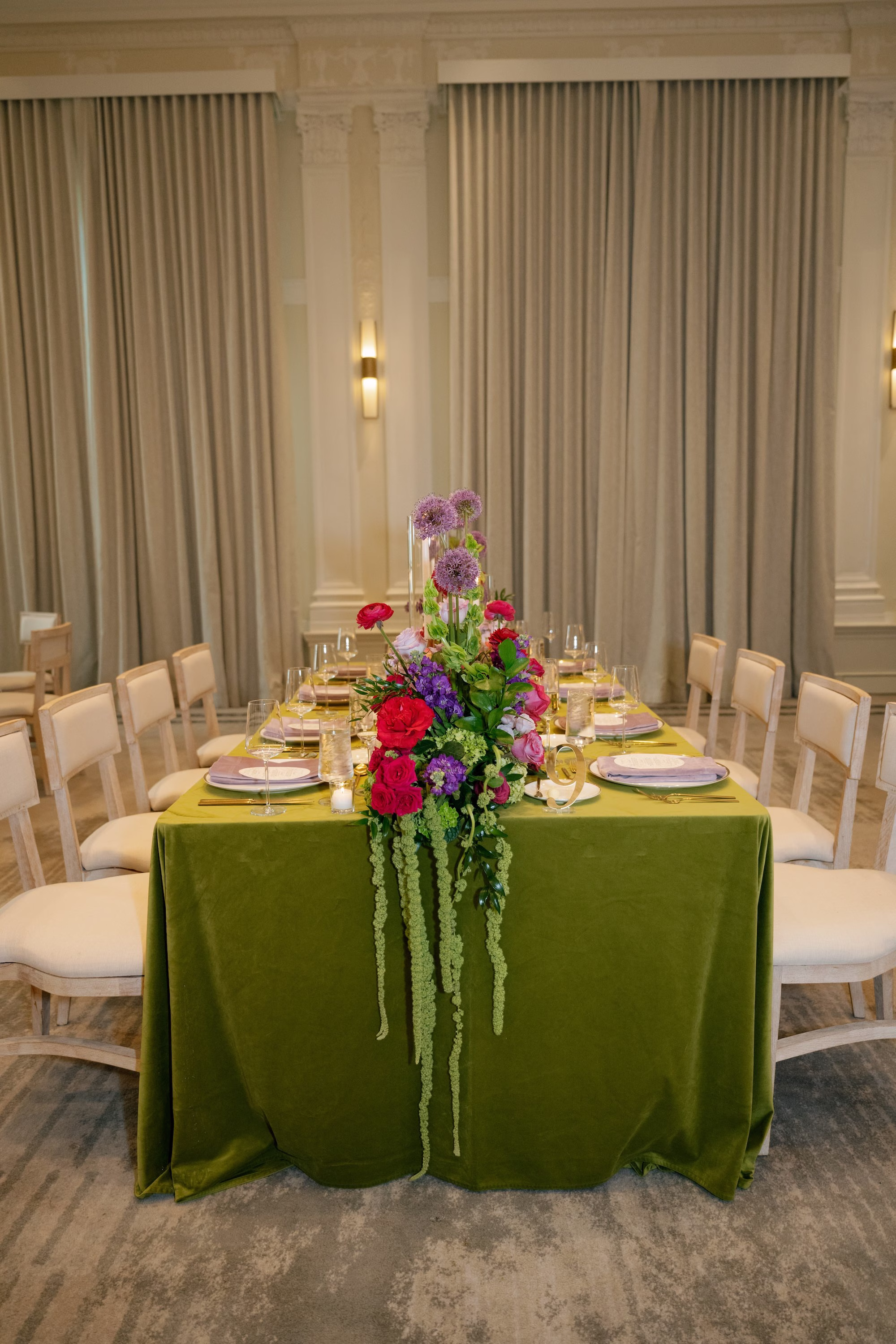 Green Velvet Linen Wedding Reception Table with Ivory Chairs and Vibrant Pink and Purple Floral Runner with Hanging Amaranthus Ideas | St. Pete Florist Bruce Wayne Florals | Planner Parties A' La Carte
