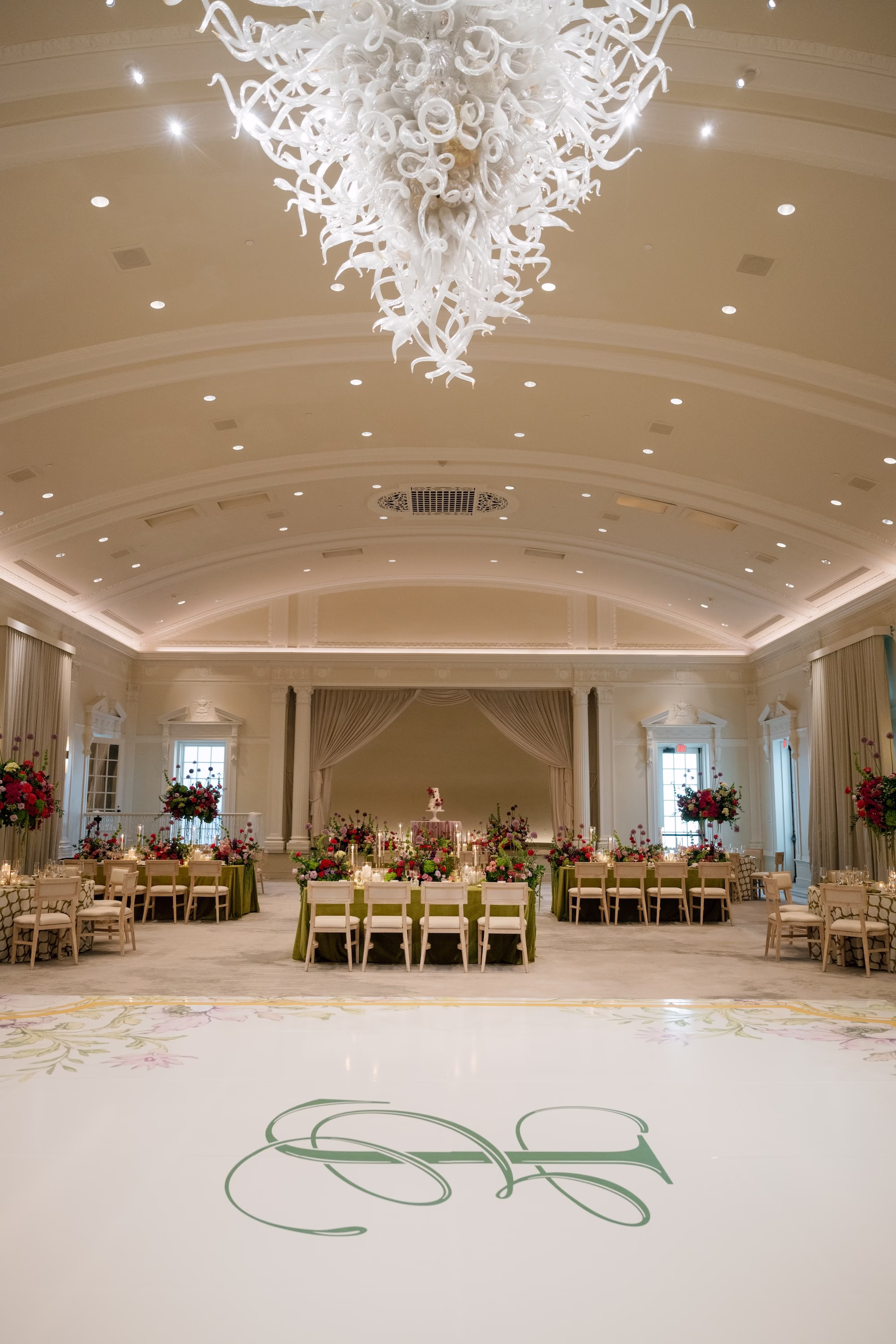 Custom White Wedding Dance Floor with Green Monogram and Floral Border Under Modern White Chandelier Reception Ideas | Grand Ballroom Wedding Reception at St. Pete Venue The Vinoy | Planner Parties A' La Carte