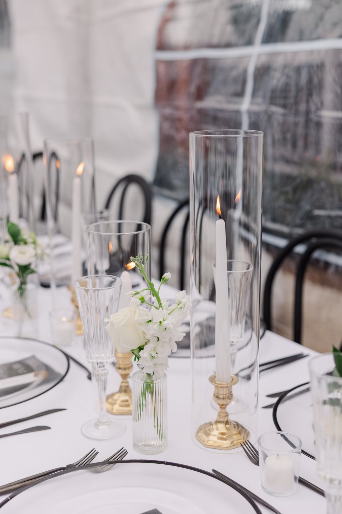 Gold Taper Candle Holders, Glass Hurricanes and White Rose Bud Vases with Black Flatware Wedding Reception Tablescape Ideas | Palmetto Rentals Kate Ryan Event Rentals