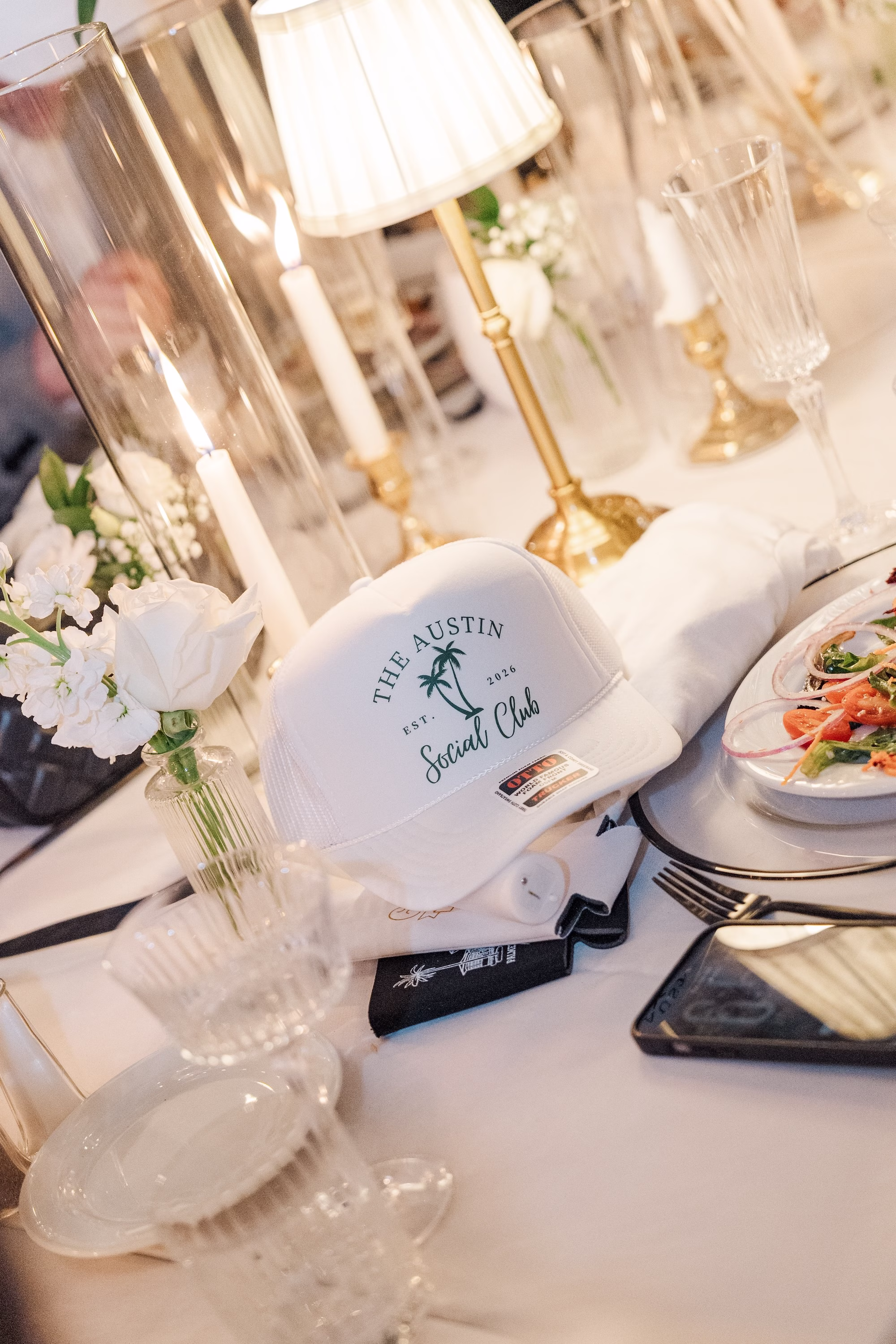 Custom The Austin Social Club Trucker Hat at Wedding Reception Place Setting with Gold Candlestick Lamp Ideas