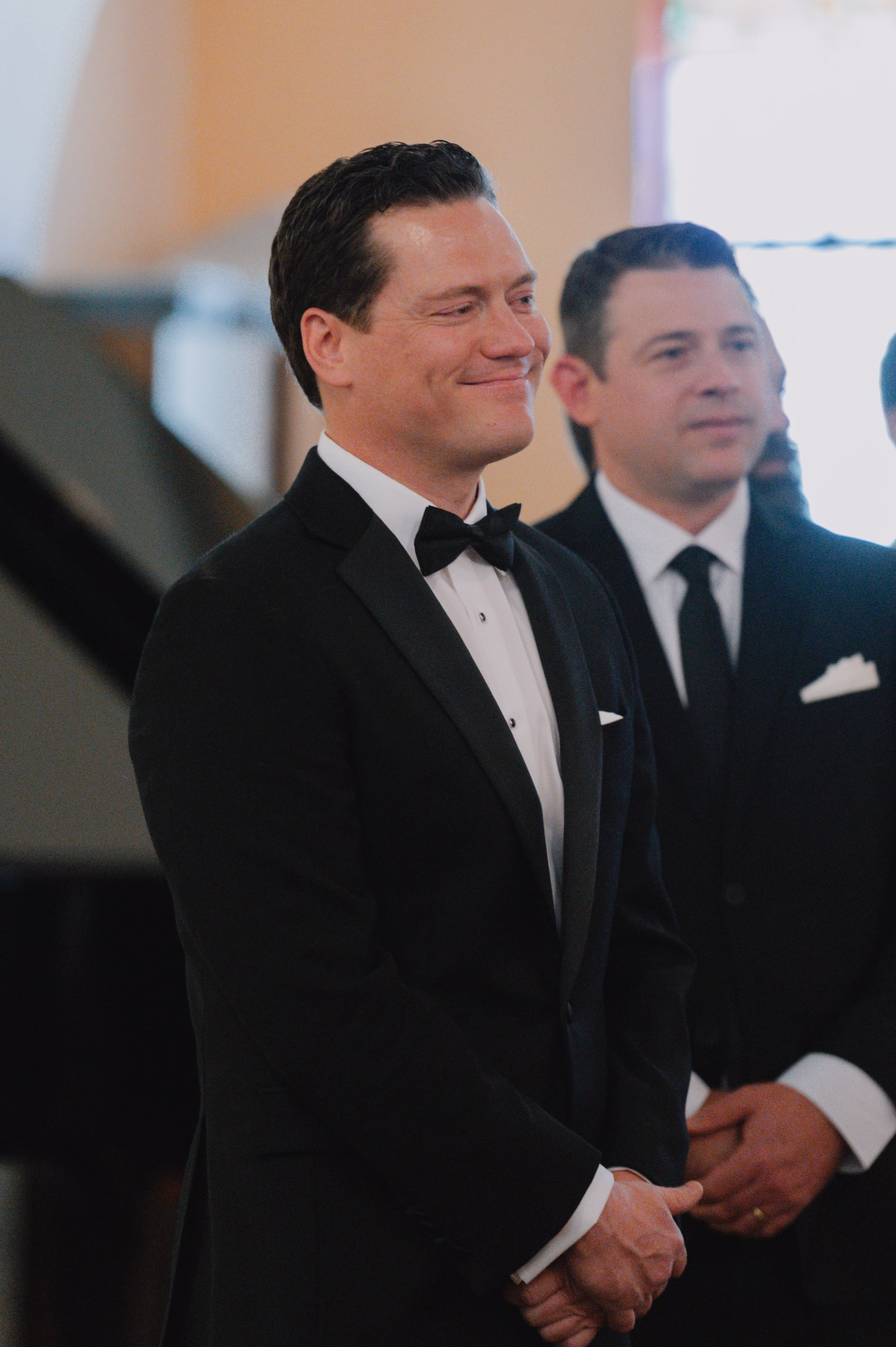 7Classic Modern Black and White Wedding Ideas - Modern Black and Ivory Ybor City Wedding | J.C. Newman Cigar Co. Groom's Reaction to Bride Walking Down Wedding Ceremony Aisle in Black Tuxedo