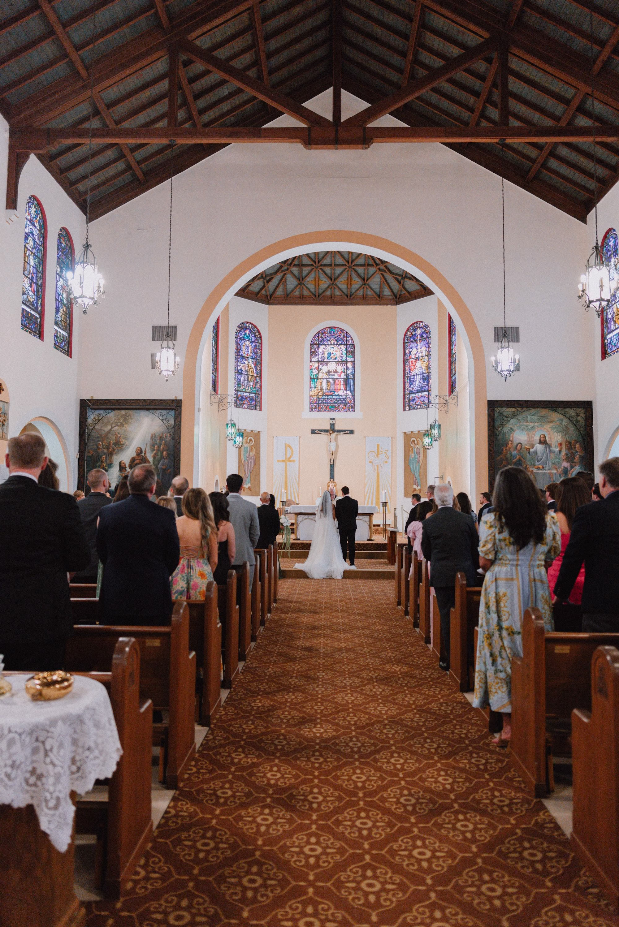 9Classic Modern Black and White Wedding Ideas Tampa Venue Our Lady of Perpetual Help Catholic Church - Modern Black and Ivory Ybor City Wedding | J.C. Newman Cigar Co. Traditional Catholic Church Wedding Ceremony with Stained Glass Windows and Wood Beam Ceiling | Wedding Ceremony at Tampa Venue Our Lady of Perpetual Help Catholic Church