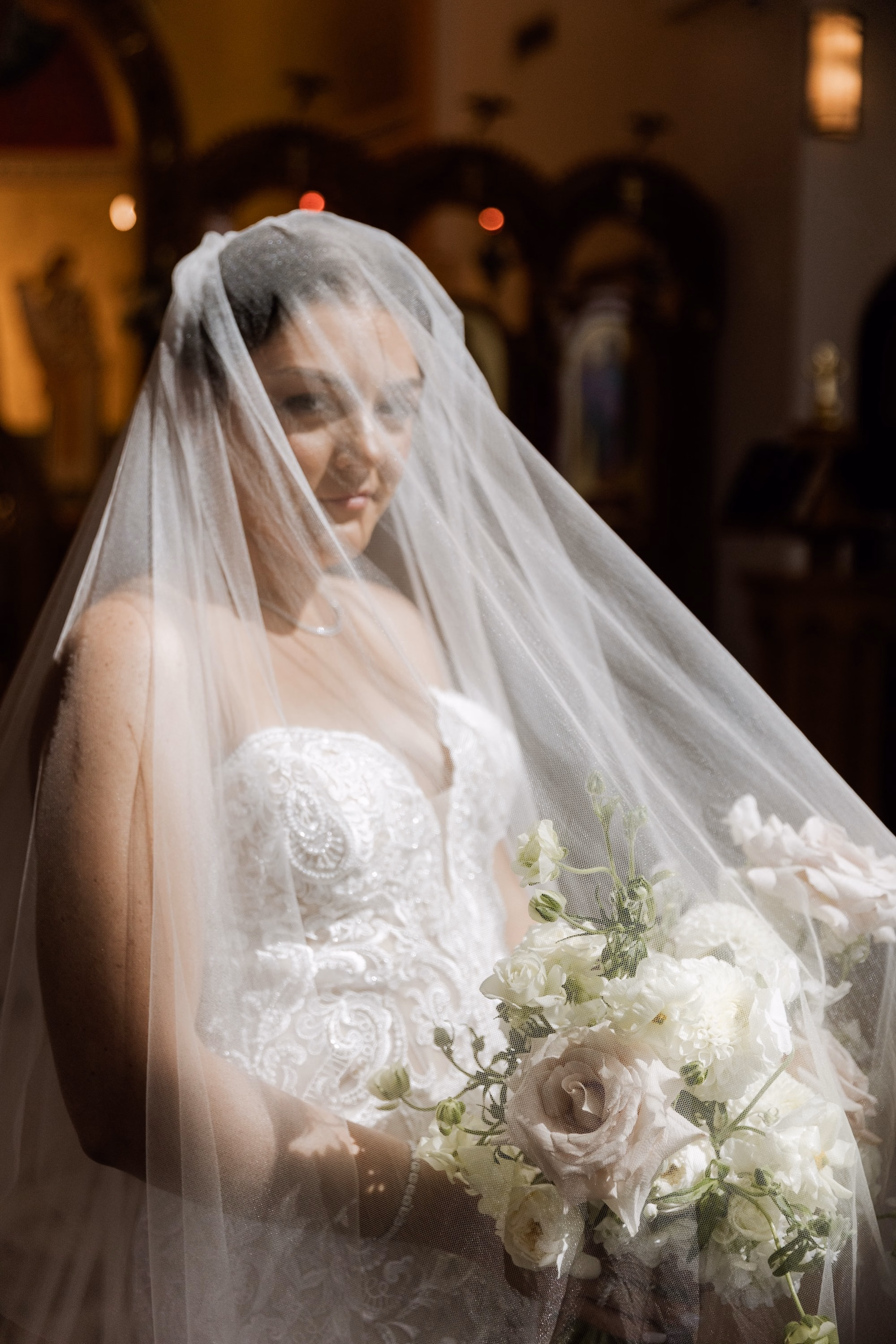 20Luxurious Romantic Garden Ballroom Wedding Inspiration - Luxurious Garden-Inspired Naples Wedding | Hyatt Regency Coconut Point Bride Under Cathedral Veil Wedding Portrait | Soft Candlelit Church Bridal Portrait Inspiration | White Rose and Garden Rose Bouquet Ideas