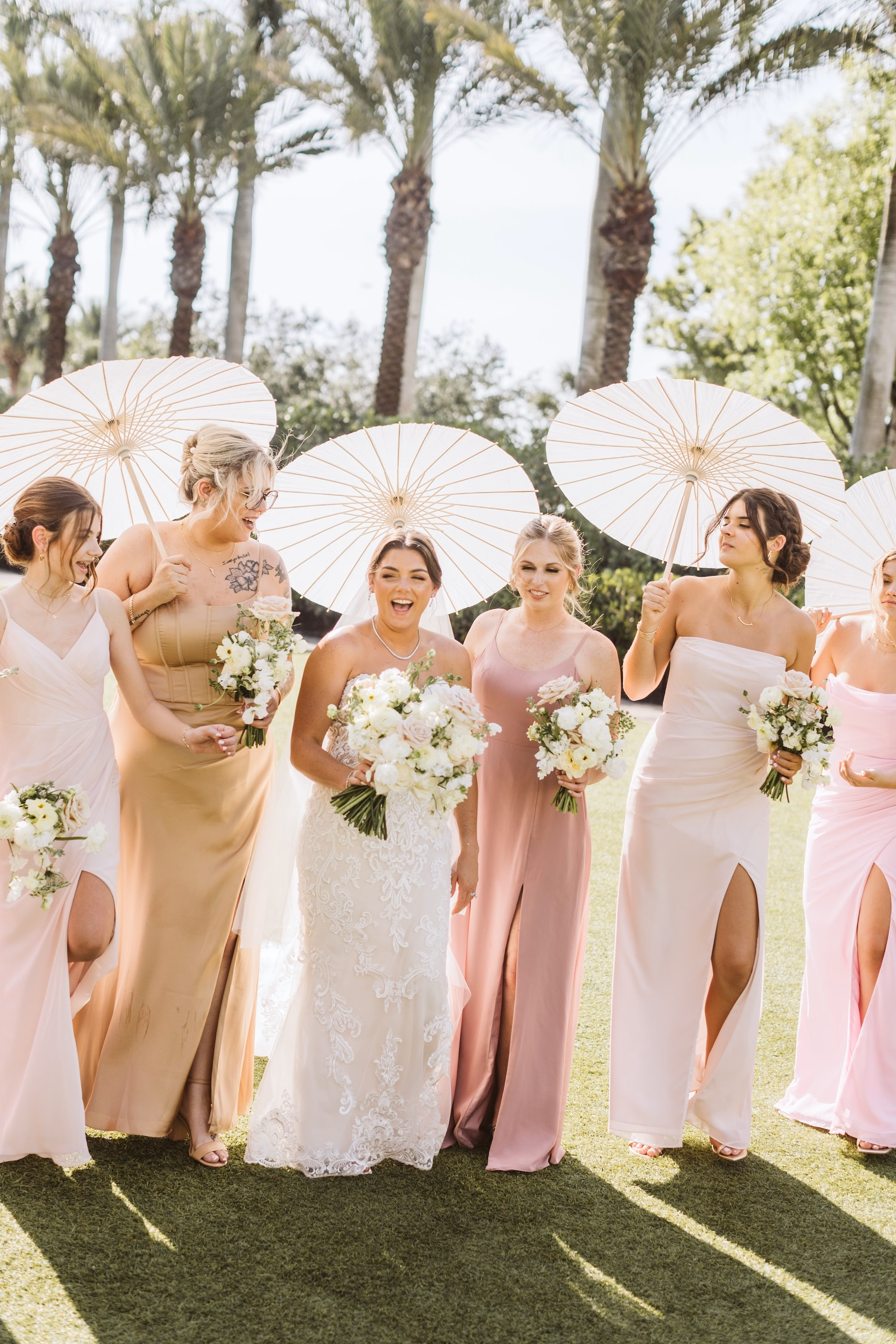 23Luxurious Romantic Garden Ballroom Wedding Inspiration - Luxurious Garden-Inspired Naples Wedding | Hyatt Regency Coconut Point Bride with Bridesmaids Wedding Portrait Under Ivory Parasols | Mismatched Blush and Champagne Bridesmaid Dresses Inspiration | Tropical Palm Tree Wedding Portrait Ideas | Bonita Springs Venue Hyatt Regency Coconut Point