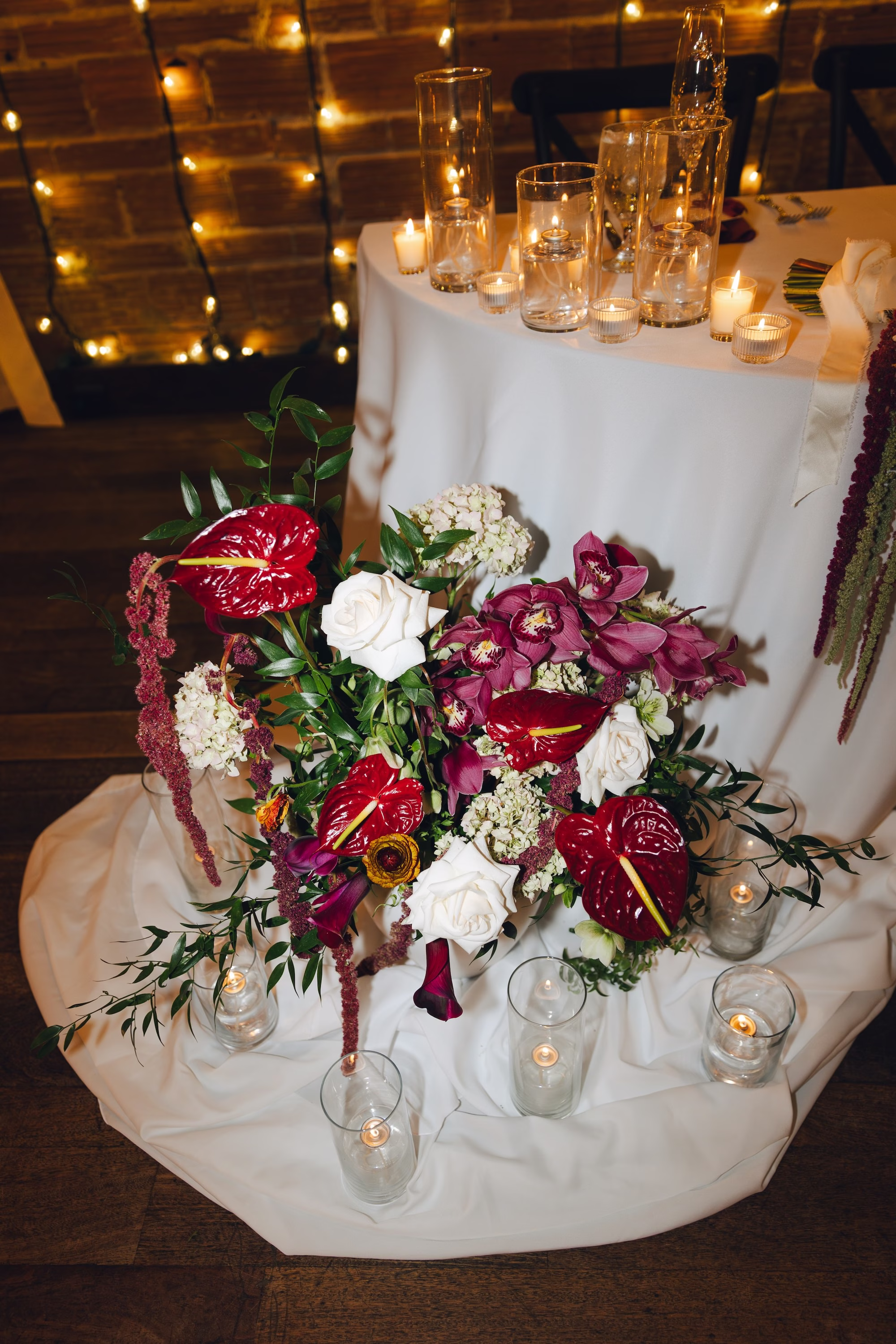 25Burgundy Vintage Romance Wedding Ideas - Vintage Romance Pink and Burgundy Downtown St. Pete Wedding | NOVA 535 Sweetheart Table Floral Arrangement with Burgundy Anthurium, Orchids, White Roses and Hanging Amaranthus Surrounded by Candles Decor Ideas