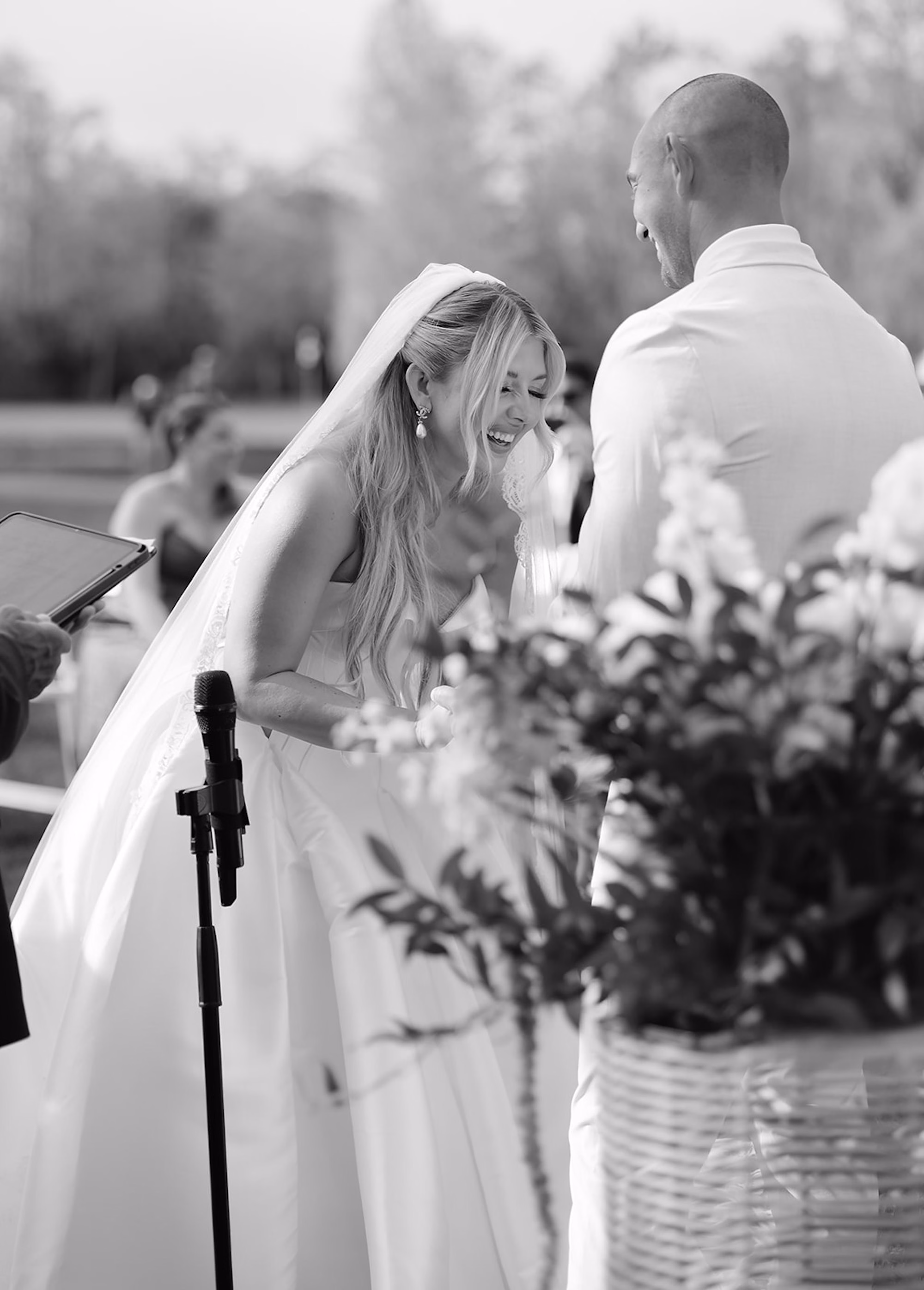 Black and White Photo of Bride and Groom Looking at Each Other During Wedding Vows