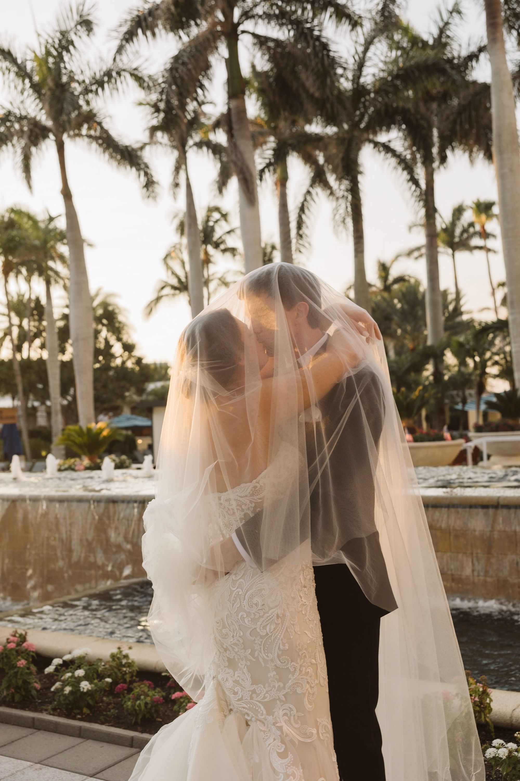 26Luxurious Romantic Garden Ballroom Wedding Inspiration - Luxurious Garden-Inspired Naples Wedding | Hyatt Regency Coconut Point Bride and Groom Kissing Under Cathedral Veil Wedding Portrait | Golden Hour Tropical Wedding Portrait Inspiration | Scalloped Lace Veil Trim Ideas | Bonita Springs Venue Hyatt Regency Coconut Point